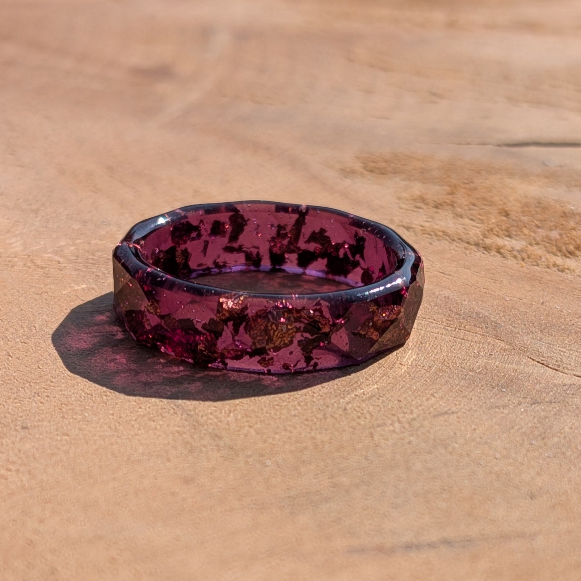 Hexagonal purple and black patterned dish on a wooden surface