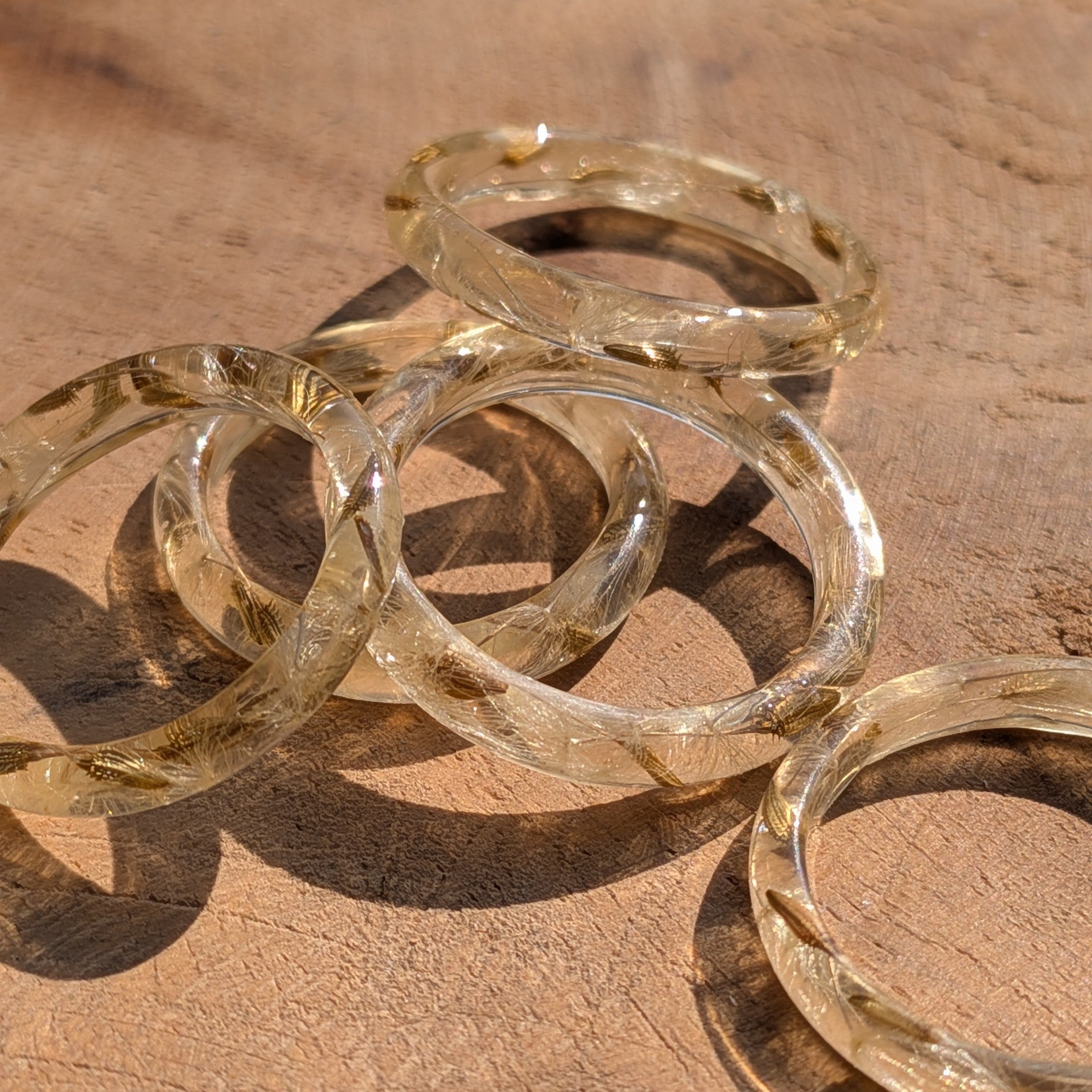 Gold bangles on a wooden surface