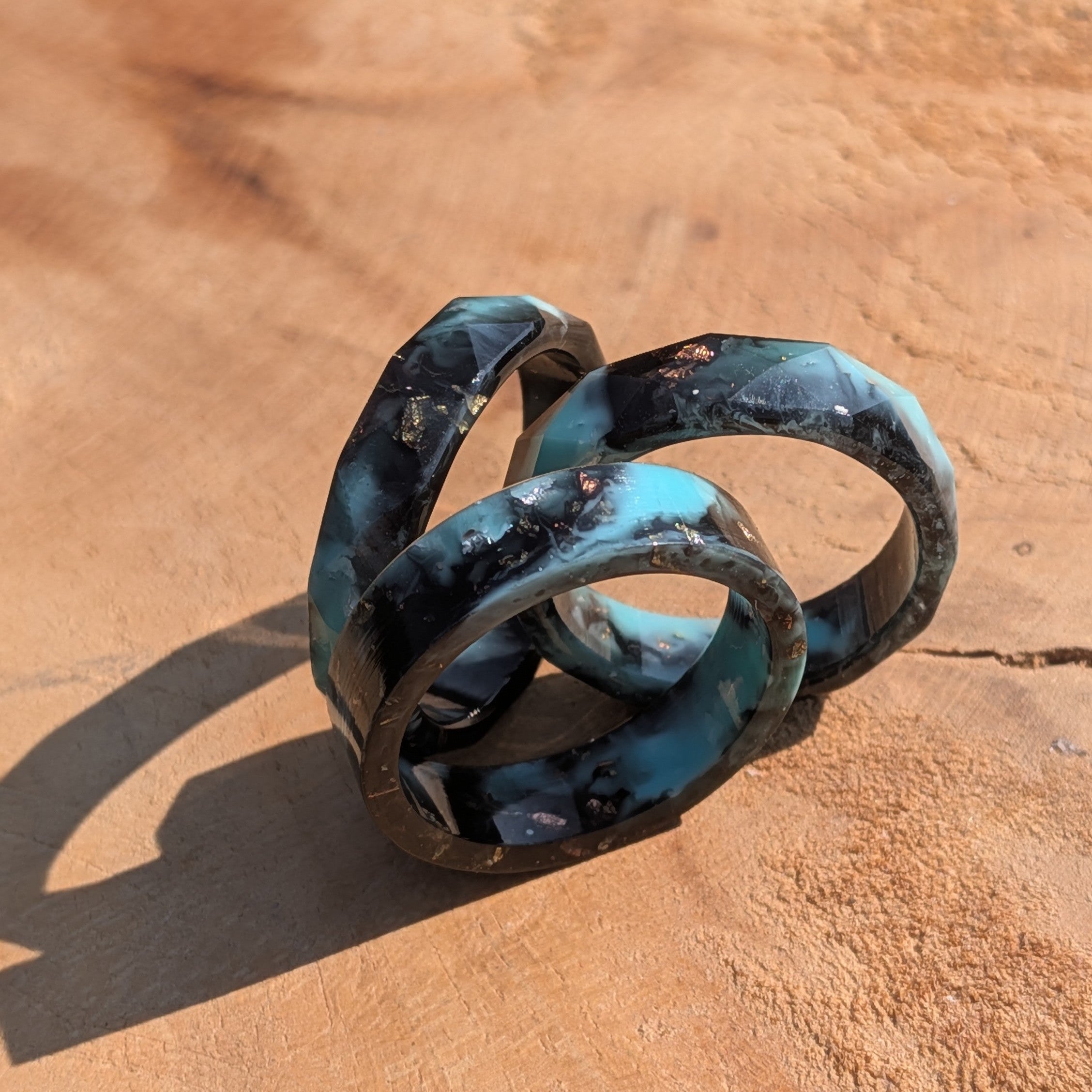 Pair of blue and silver rings on a brown surface