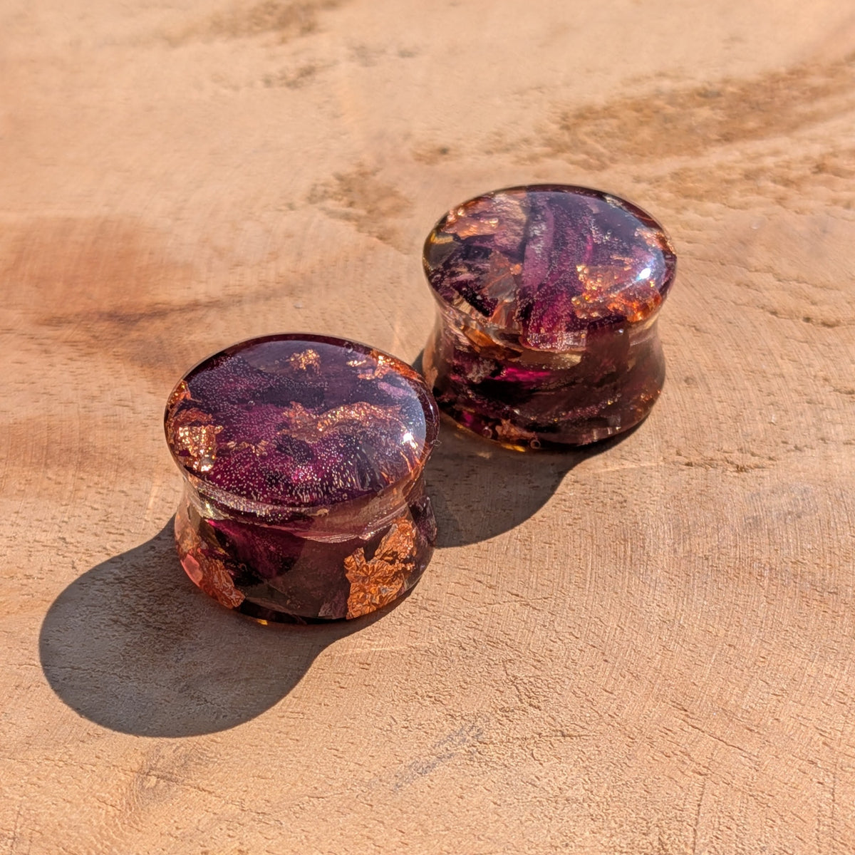 Handmade stretched ear plugs featuring a real dried rose preserved in resin EL-Creations