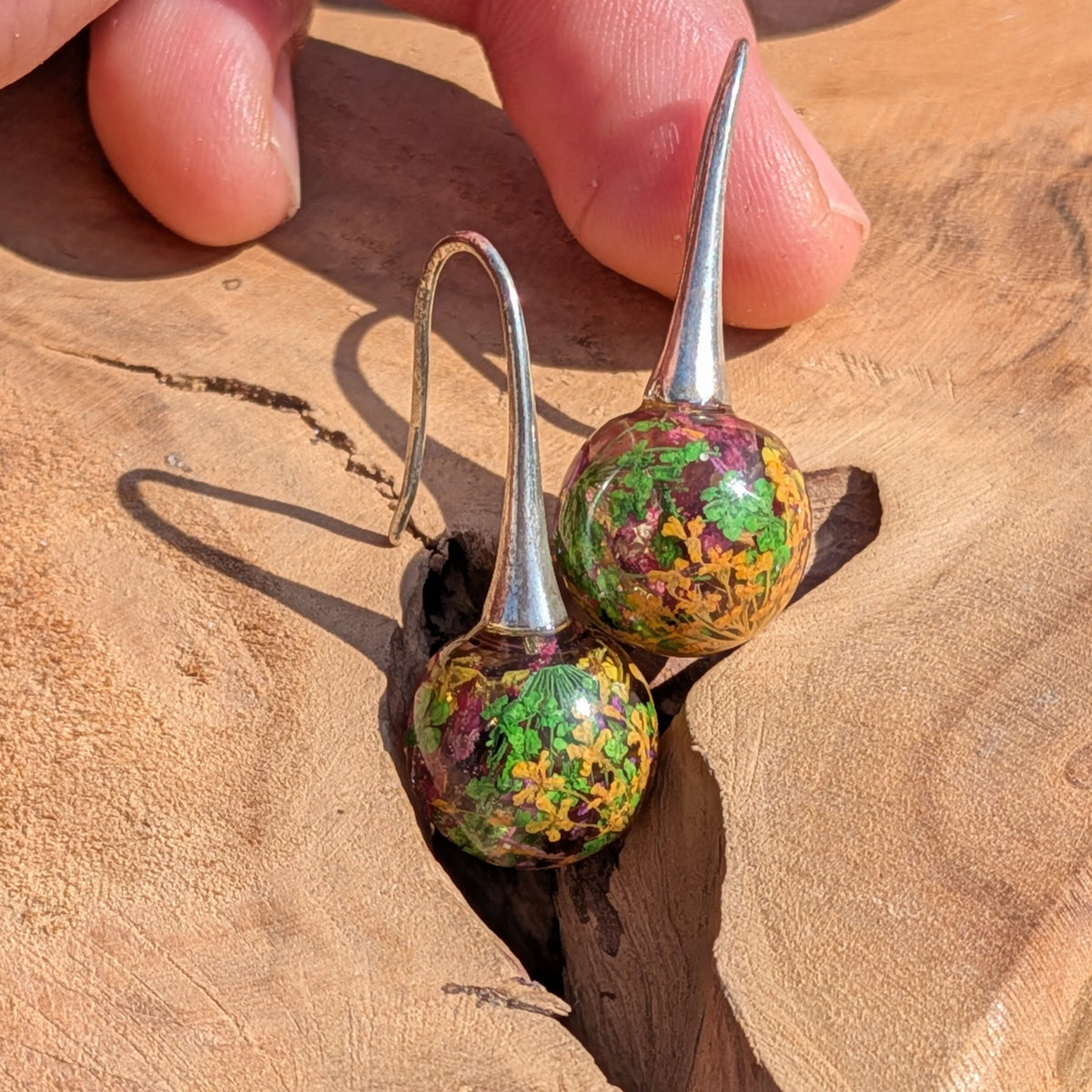 Handmade 12mm resin ball earrings with mixed dried flowers and green moss on brass hooks, EL Creations Belgium