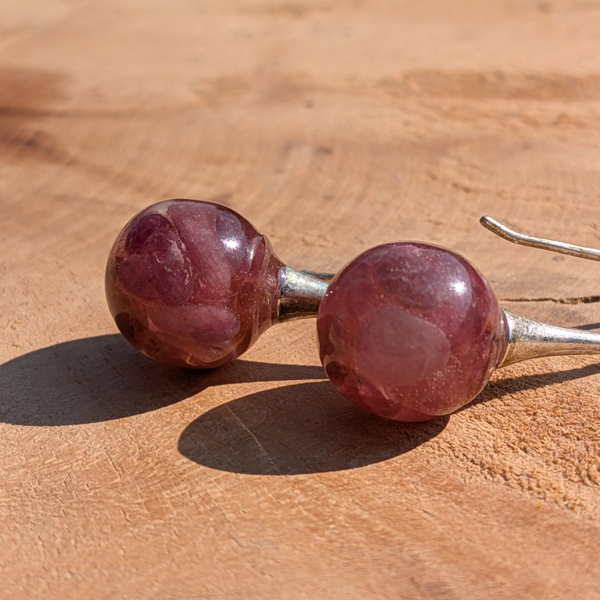 Natural pink tourmaline resin ball earrings 12mm on wooden surface, EL Creations