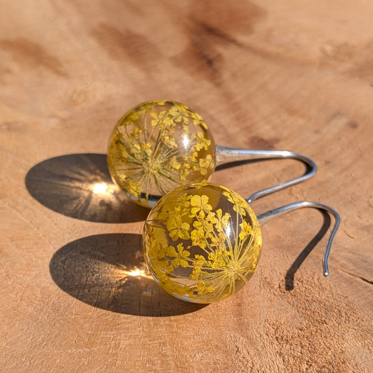 Real yellow flower resin ball earrings 15mm on wooden surface, botanical jewelry EL Creations