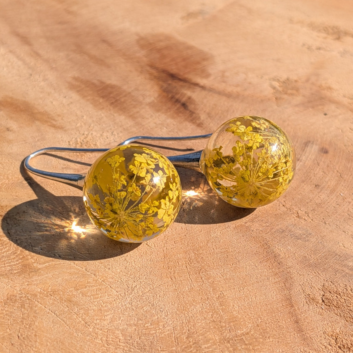 Handmade 15mm resin ball earrings with real dried yellow flowers on silver-tone hooks, EL Creations Belgium