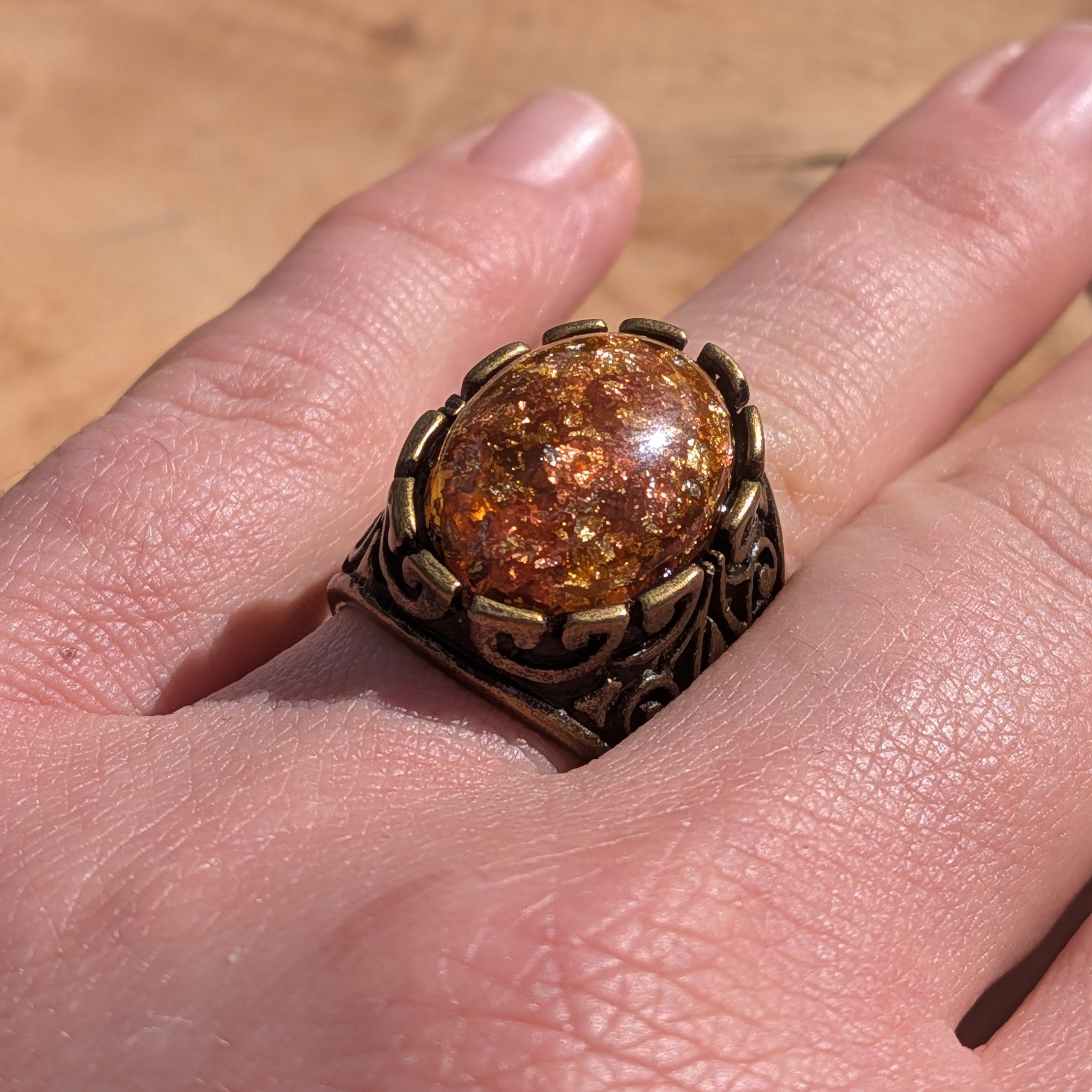 Amber resin ring antique silver filigree worn on hand front view copper gold flakes – EL-Creations