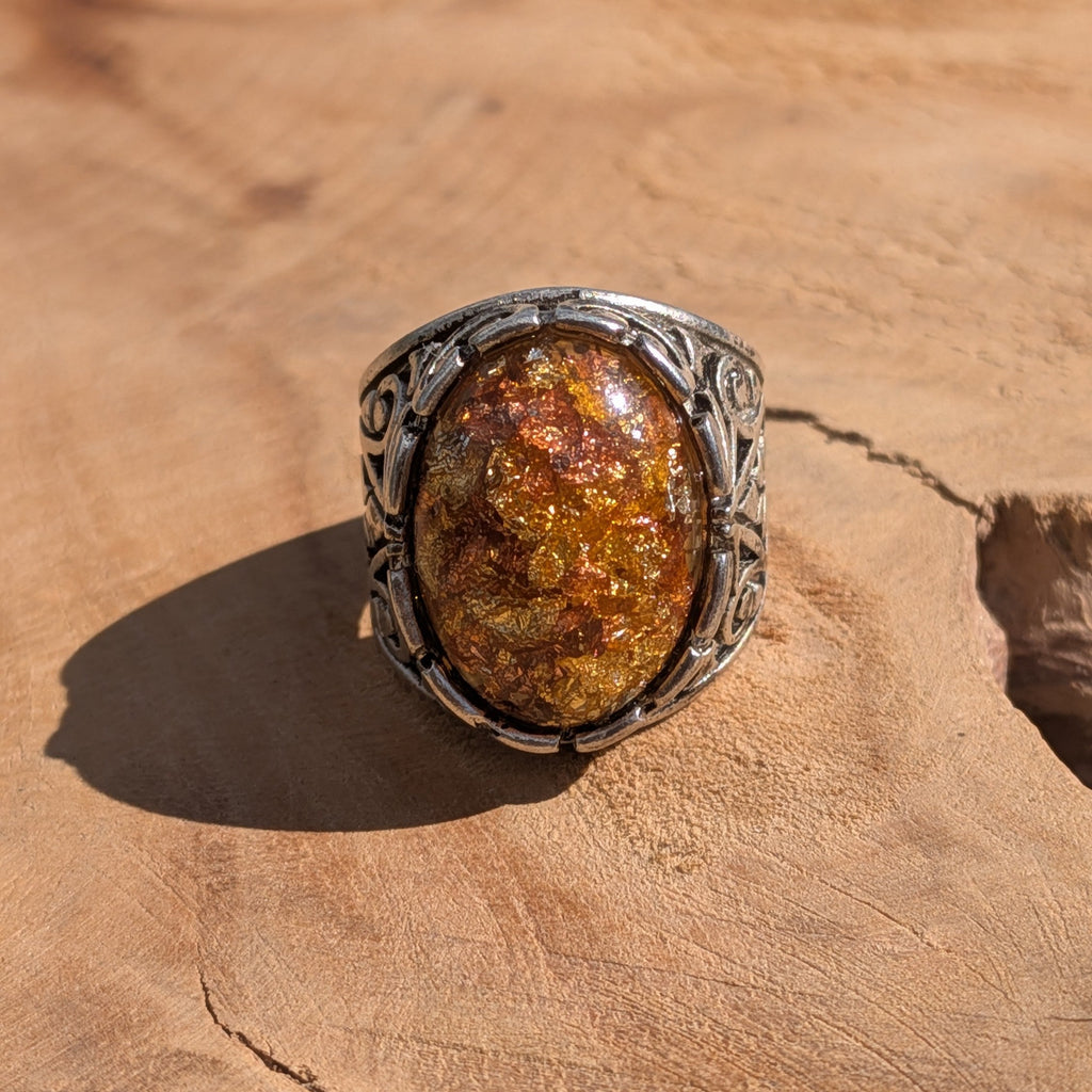 Amber resin ring antique bronze filigree base front view on stone warm tones – EL-Creations
