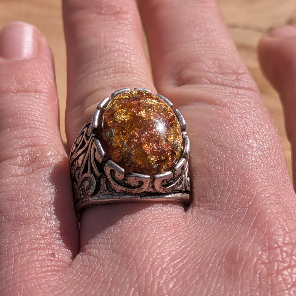 Amber resin ring antique bronze scrollwork band worn on finger side view – EL-Creations