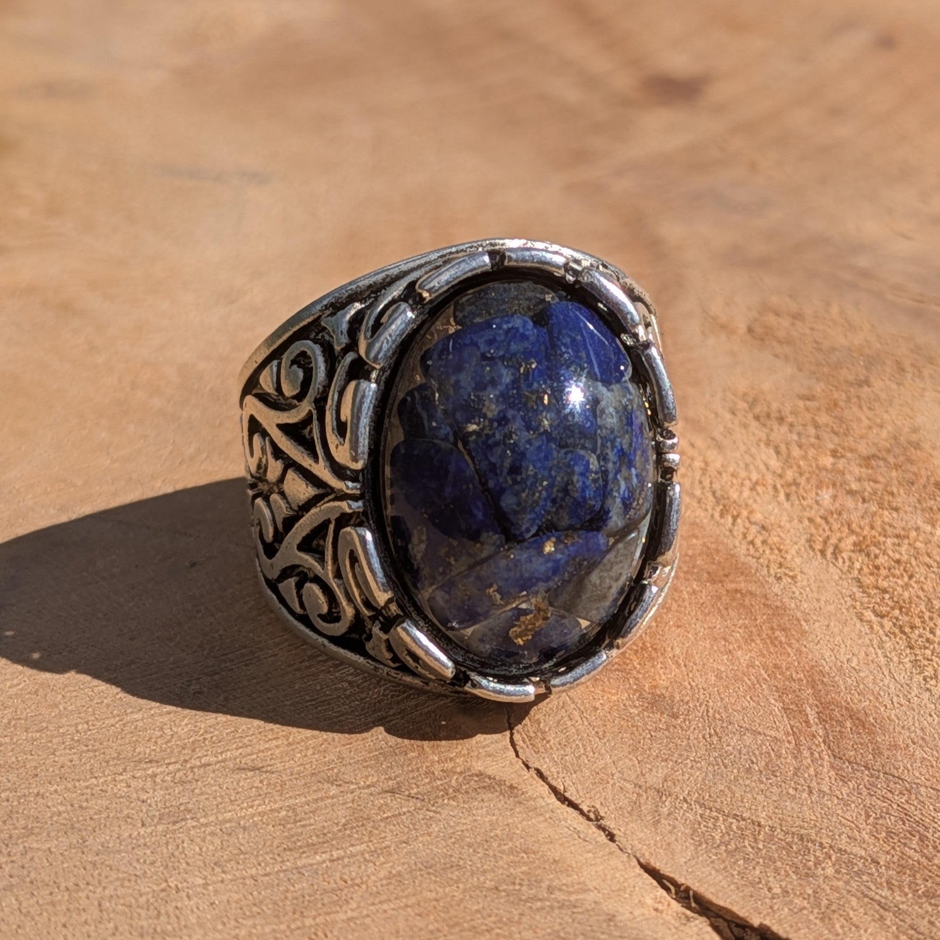 Lapis lazuli resin ring antique silver filigree scrollwork side view on stone in sunlight – EL-Creations