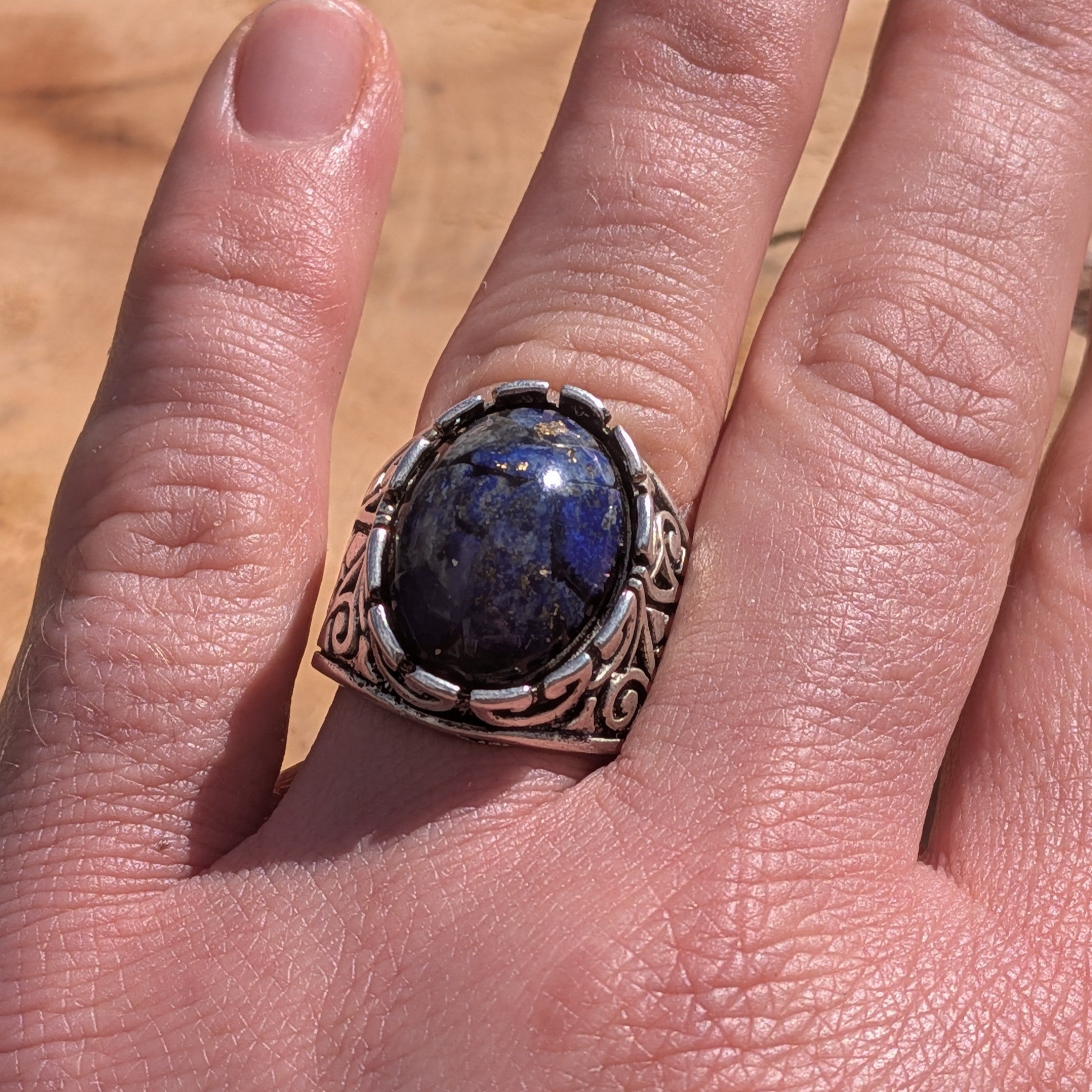 Lapis lazuli resin ring antique silver claw setting worn on finger side view – EL-Creations