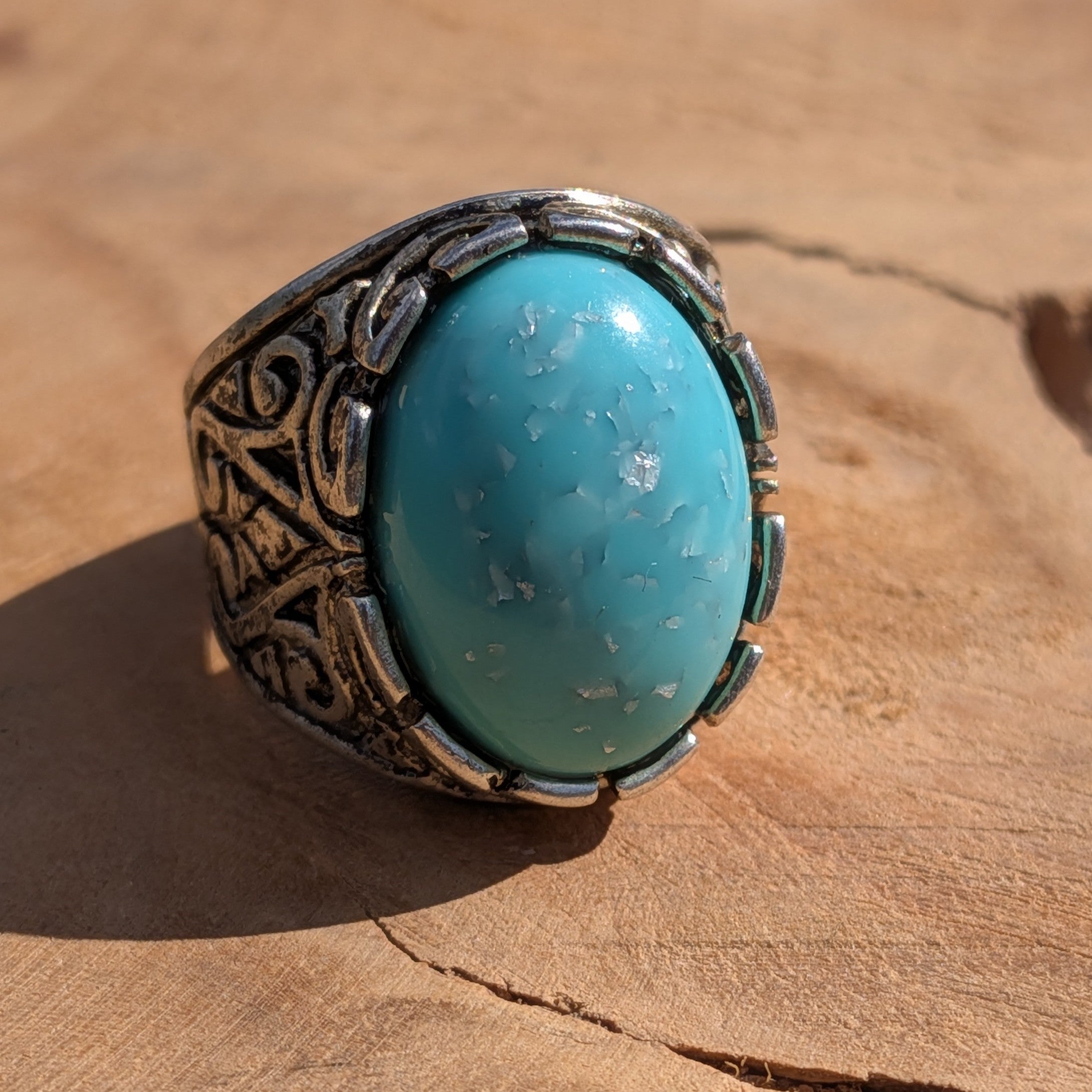Turquoise resin ring antique silver filigree scrollwork side view on wood in sunlight – EL-Creations