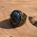 Teal blue resin ring antique bronze claw setting side view on stone copper flakes detail – EL-Creations