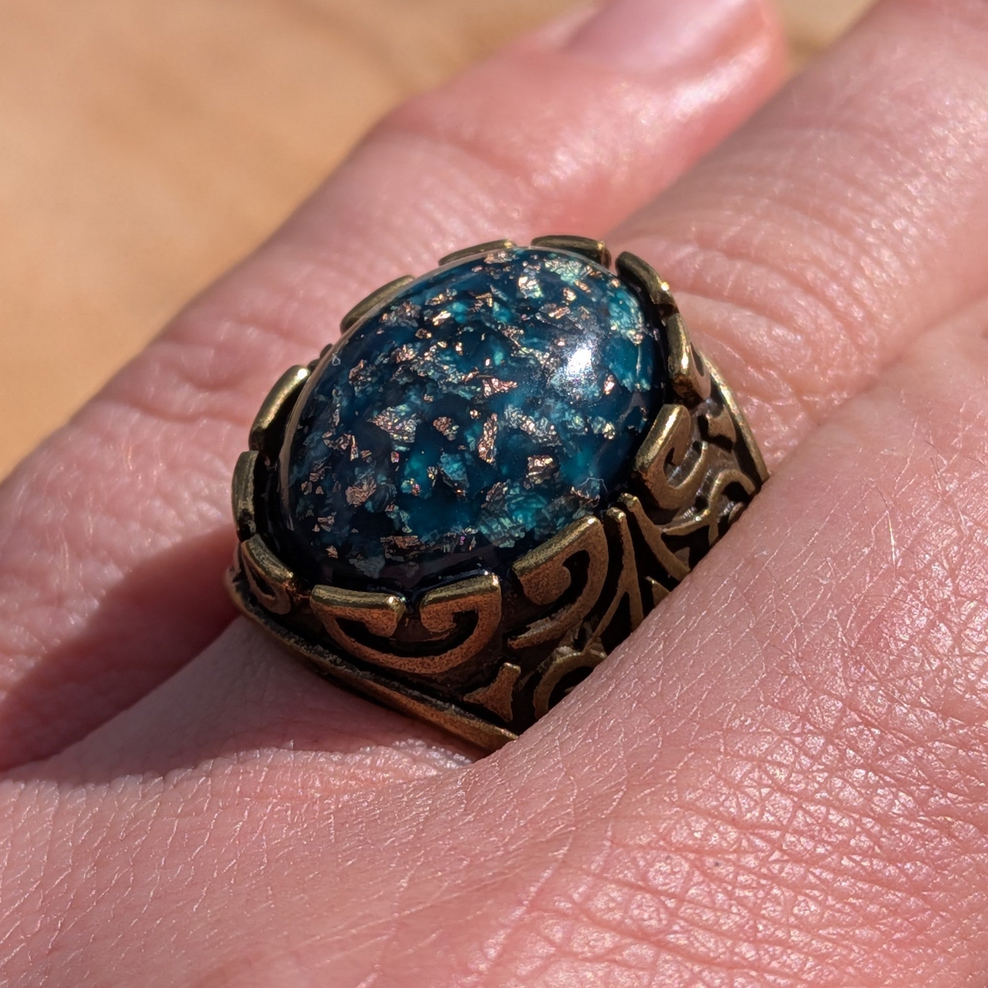 Teal blue resin ring antique bronze wide band worn on hand front view close-up – EL-Creations