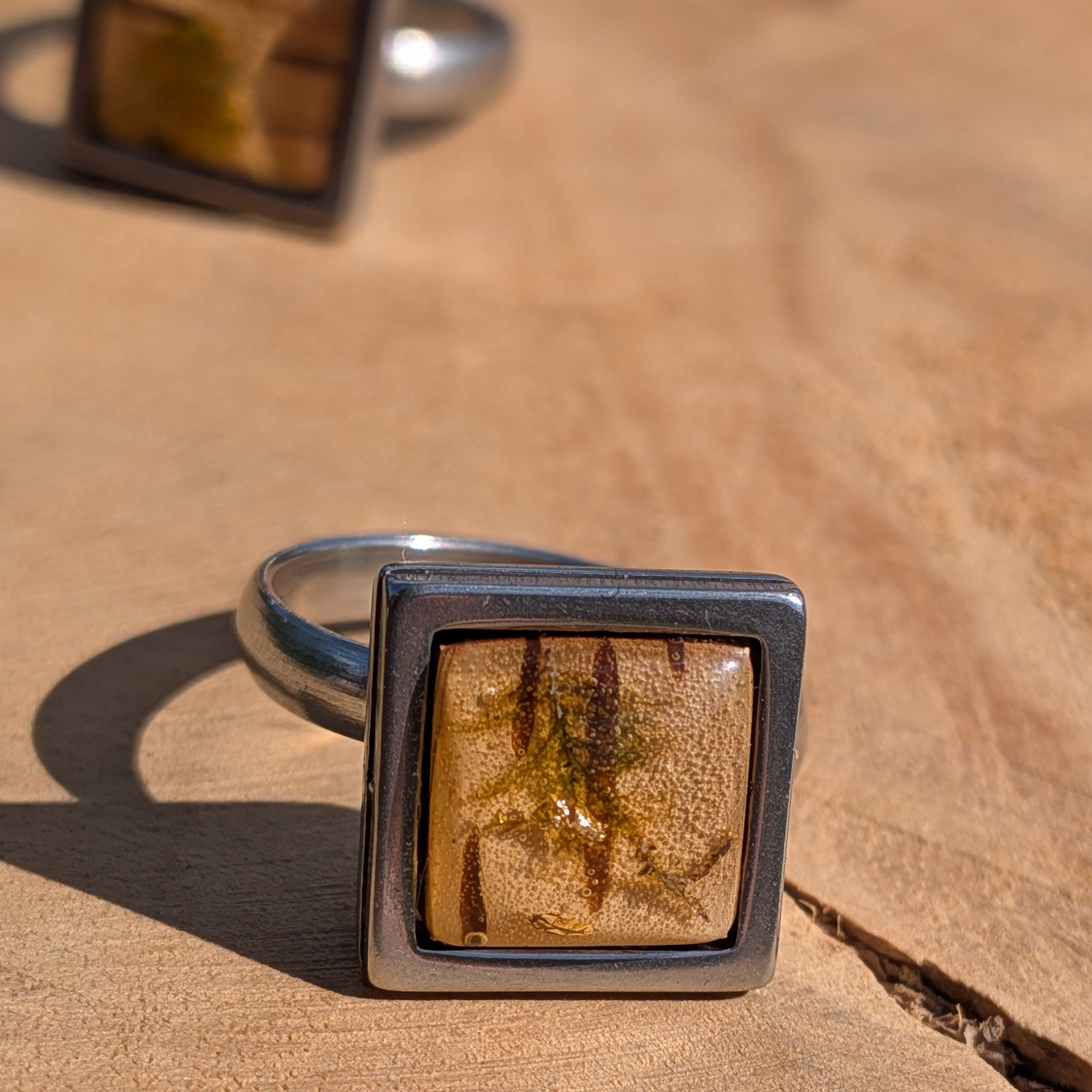 Close-up of moss and birch bark resin ring on finger, 14mm square gunmetal stainless steel bezel – EL-Creations