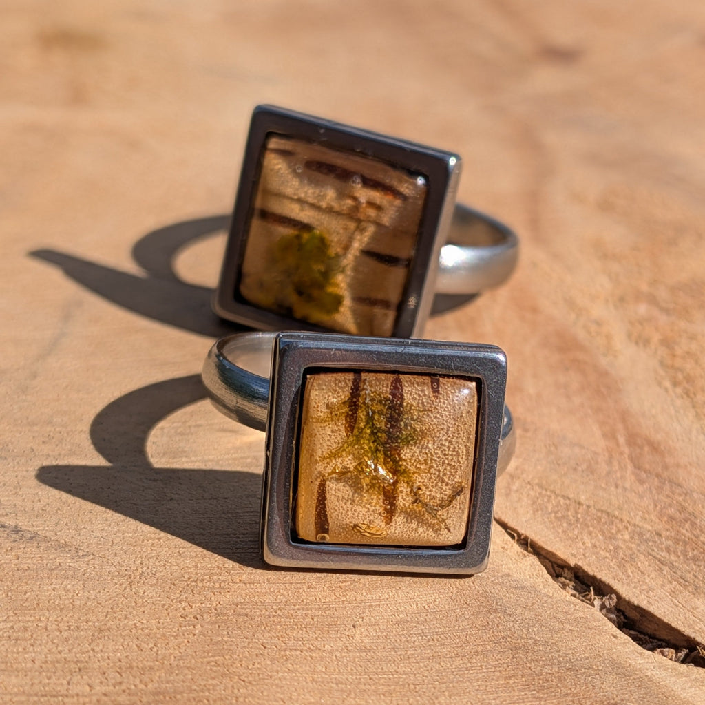 Moss birch bark resin ring worn on finger, top view of 14mm square stainless steel bezel with amber dome – EL-Creations