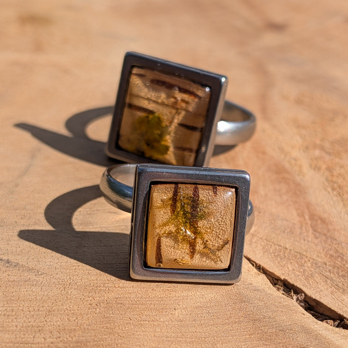 Moss birch bark resin ring worn on finger, top view of 14mm square stainless steel bezel with amber dome – EL-Creations