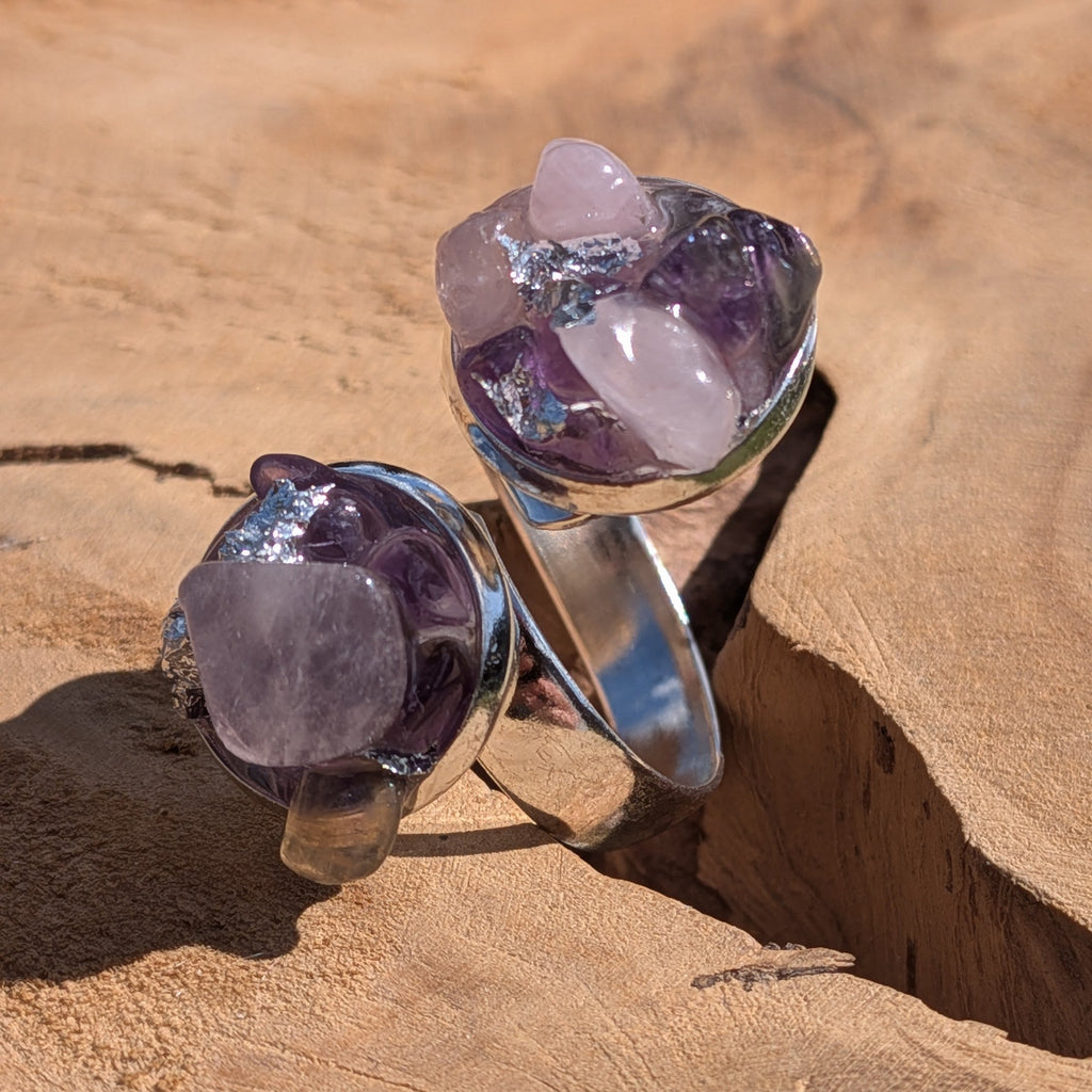 Two amethyst and rose quartz bypass rings on wooden surface, dual crystal cluster settings in silver alloy – EL-Creations