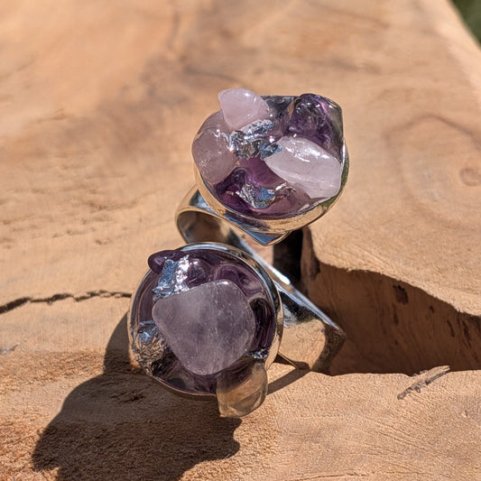 Amethyst rose quartz bypass ring on wood, close-up of two open silver settings with raw crystal clusters – EL-Creations