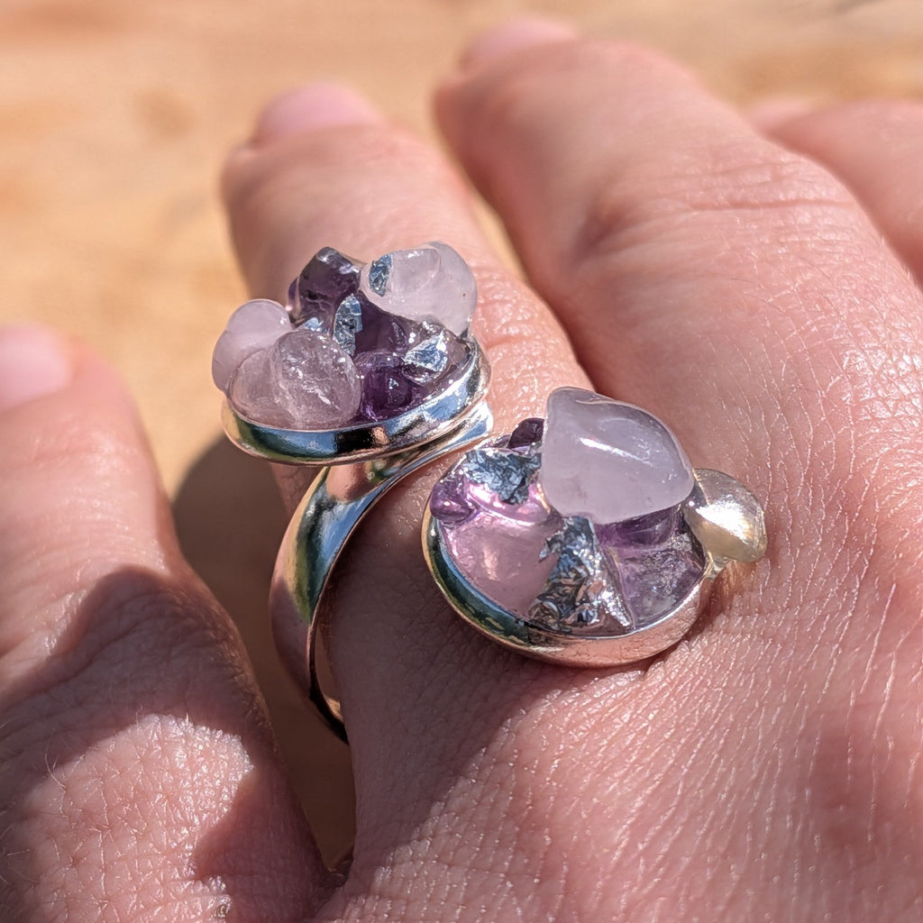 Raw amethyst rose quartz bypass ring on fingers, top view of two open silver settings with crystal clusters – EL-Creations
