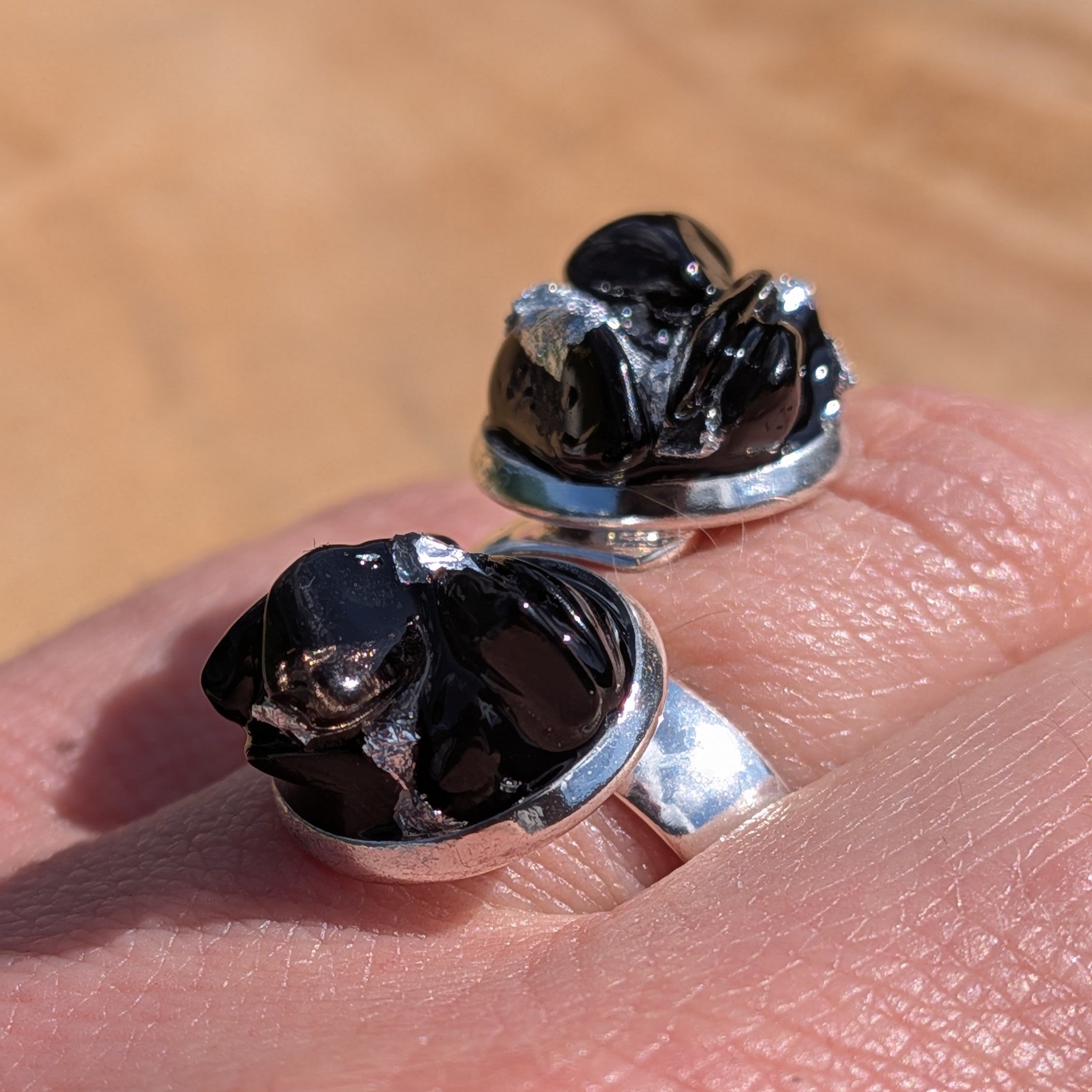 Black onyx obsidian cocktail rings on stone surface, front view, silver base – EL-Creations