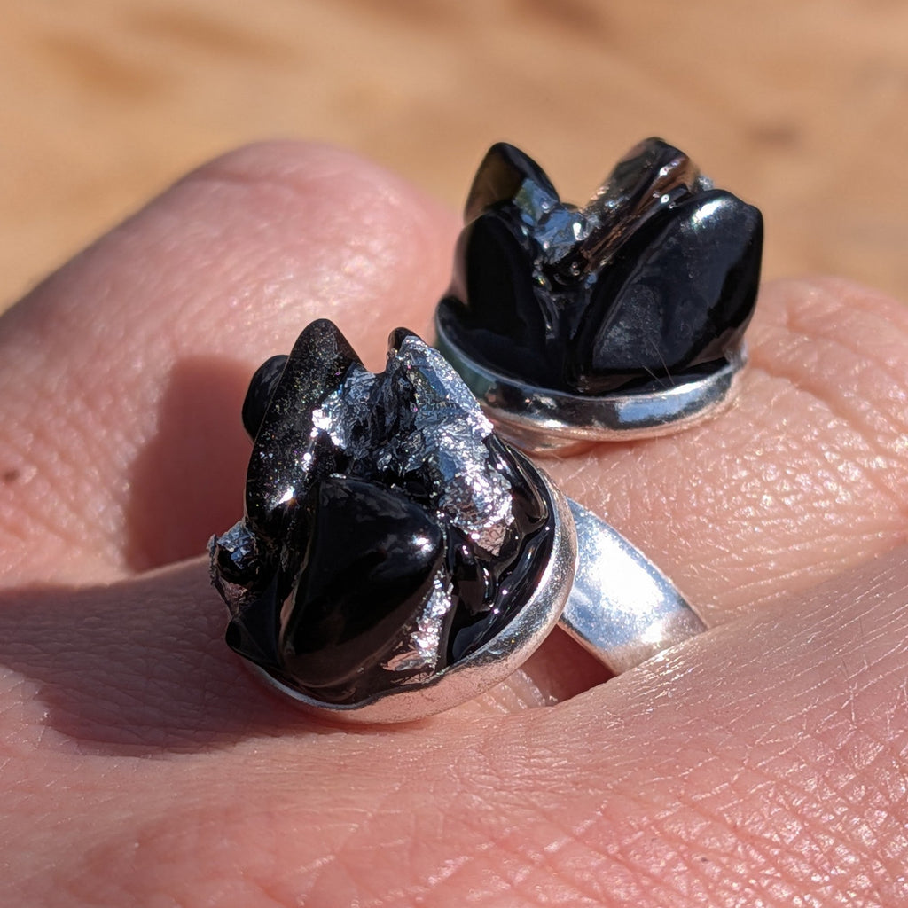 Two black onyx obsidian statement rings on finger, silver alloy base close-up – EL-Creations