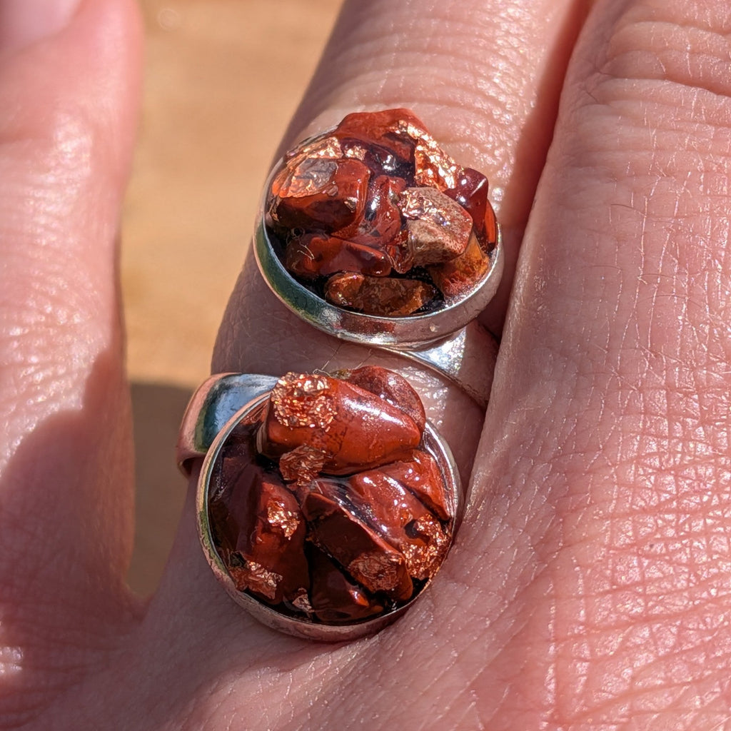 Macro close-up of red jasper double cluster ring on finger, two silver alloy settings filled with raw jasper fragments – EL-Creations