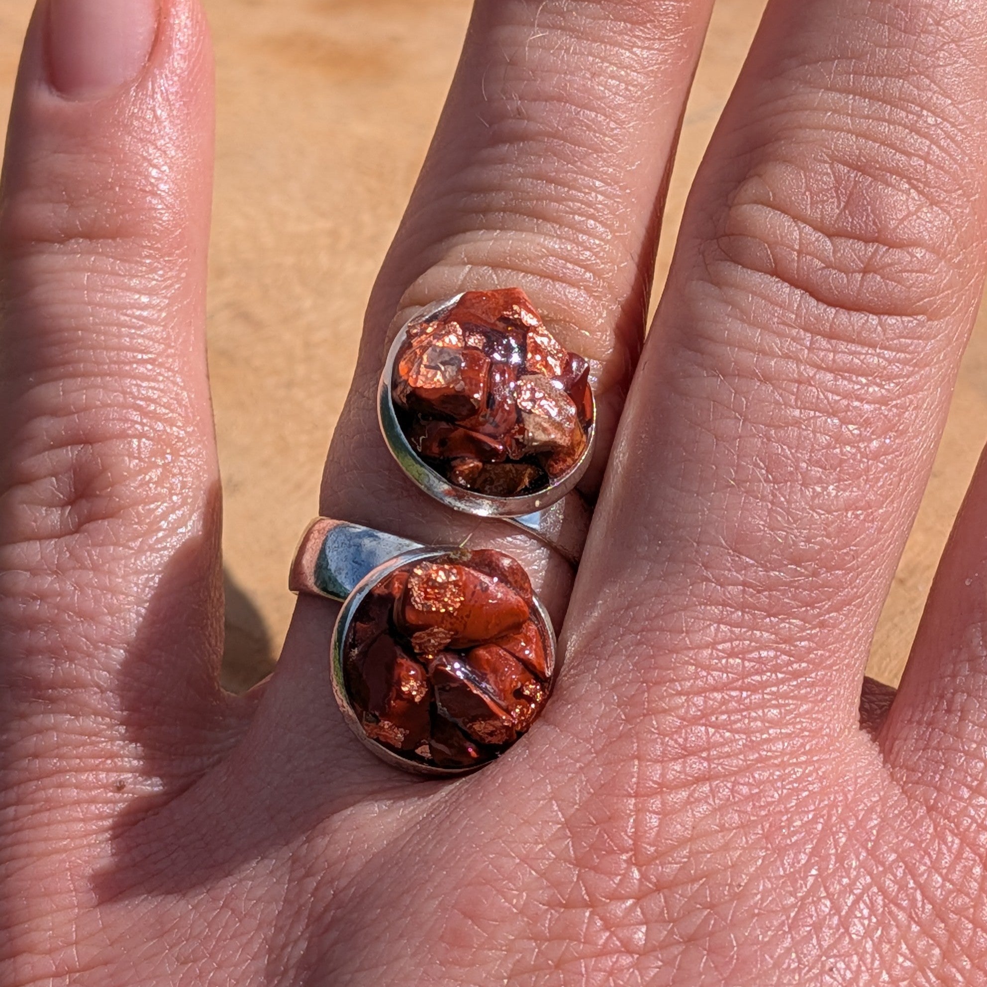Red jasper double cluster ring worn on finger, angled view of two silver alloy settings with raw stone pieces – EL-Creations