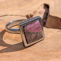 Close-up of black resin ring with burgundy skeleton leaf in square stainless steel setting – EL-Creations