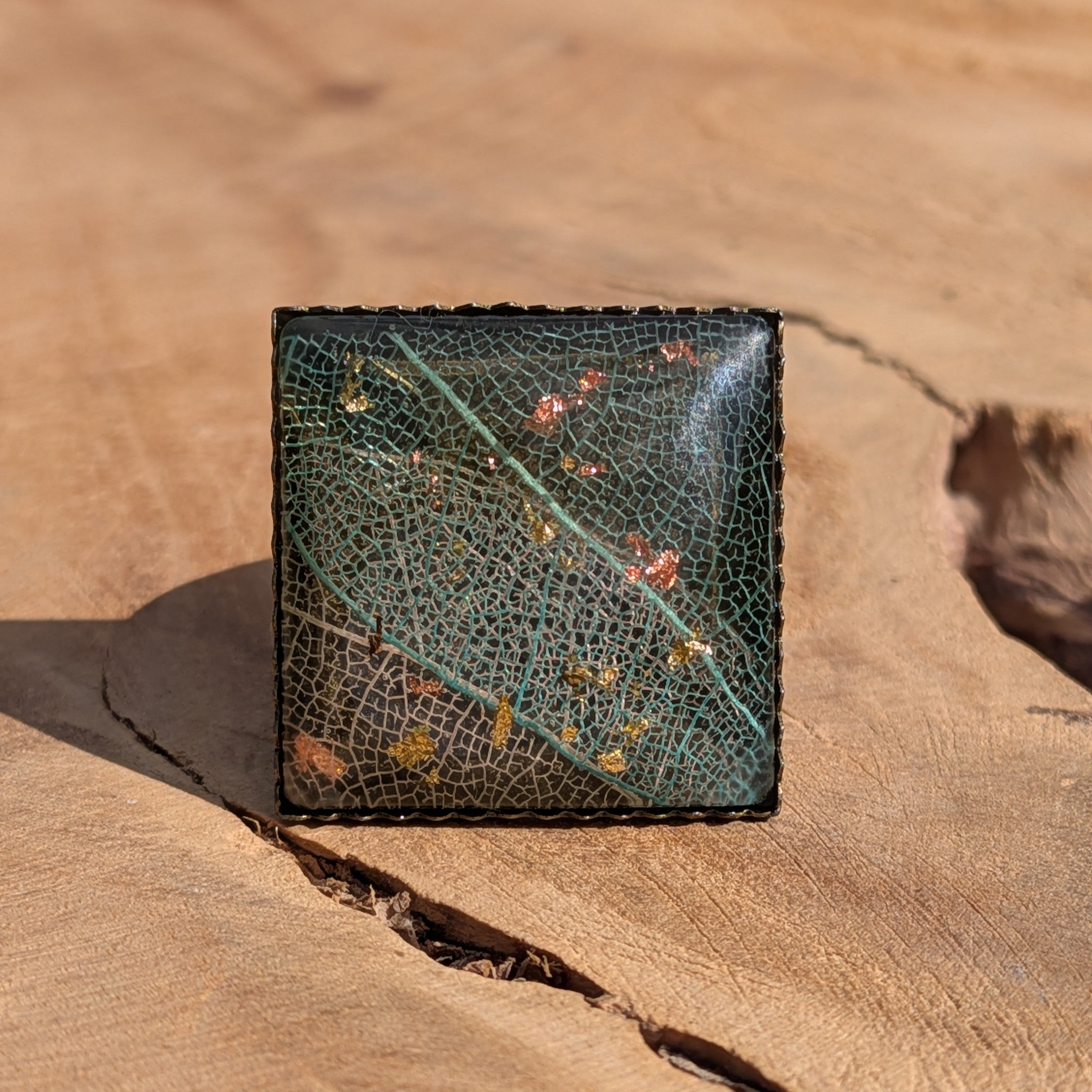 Skeleton leaf resin ring on wood, 20mm square antique bronze bezel with copper and gold flakes – EL-Creations