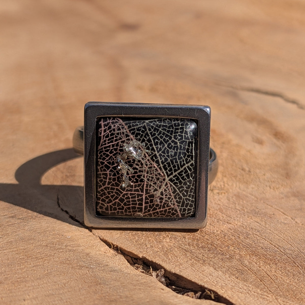 Black skeleton leaf resin ring on wood, 15mm square stainless steel bezel with gloss dome – EL-Creations