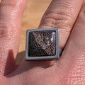 Top view of black resin ring on hand, skeleton leaf detail in 15mm square stainless steel setting – EL-Creations