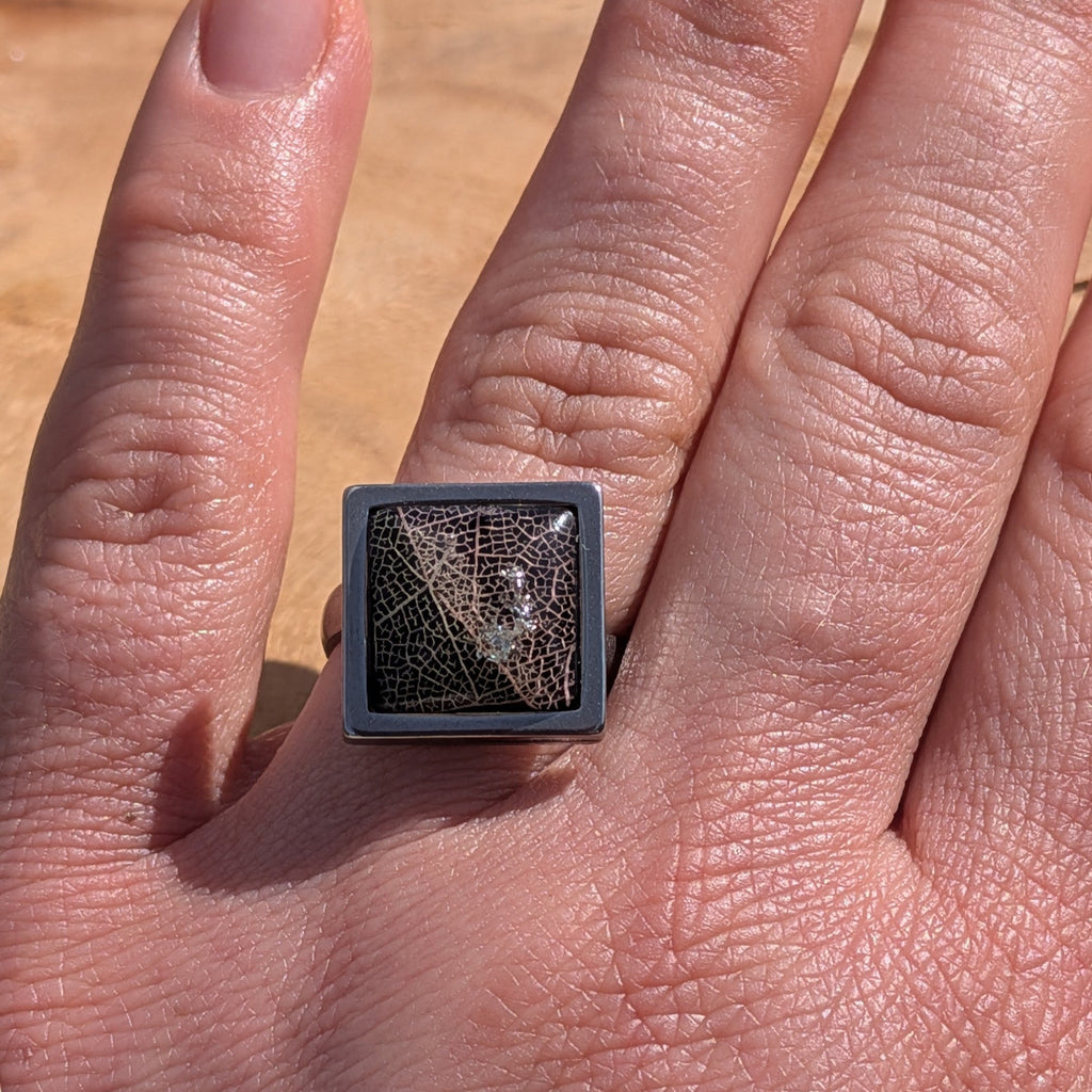 Handcrafted black skeleton leaf resin ring on hand, square stainless steel setting 15mm – EL-Creations