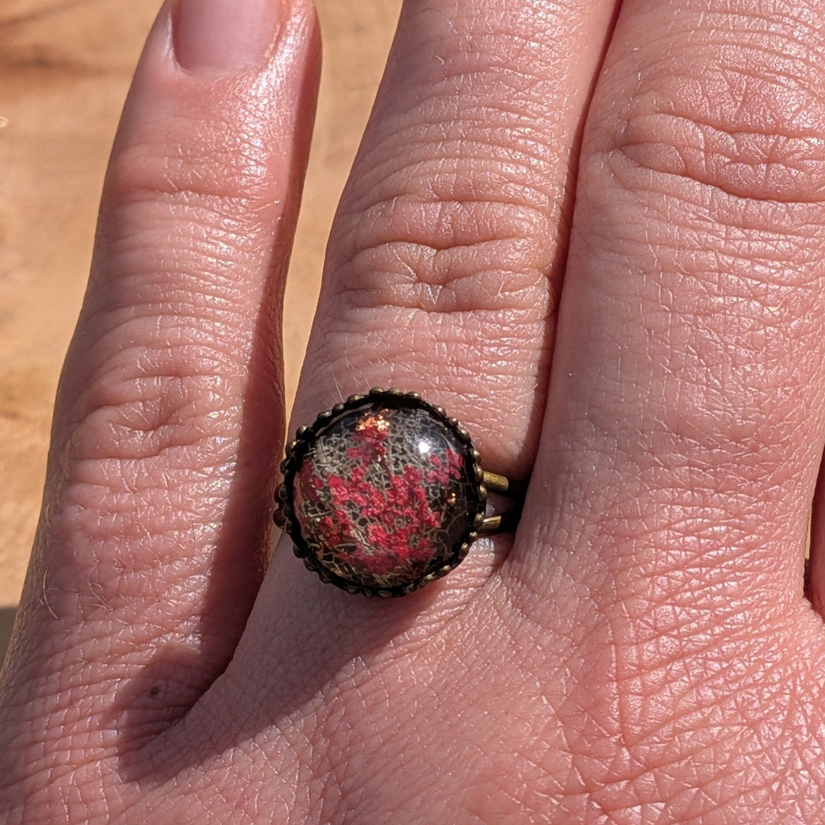 Handcrafted red Queen Anne's Lace skeleton leaf resin ring on hand, antique bronze crown bezel – EL-Creations