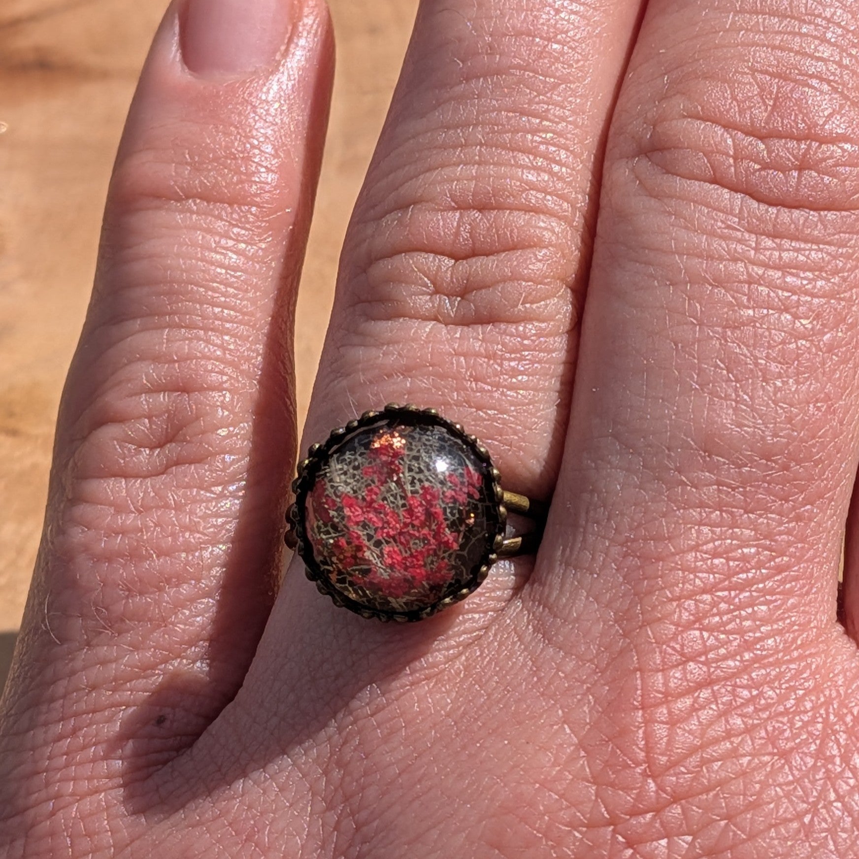 Handcrafted red Queen Anne's Lace skeleton leaf resin ring on hand, antique bronze crown bezel – EL-Creations