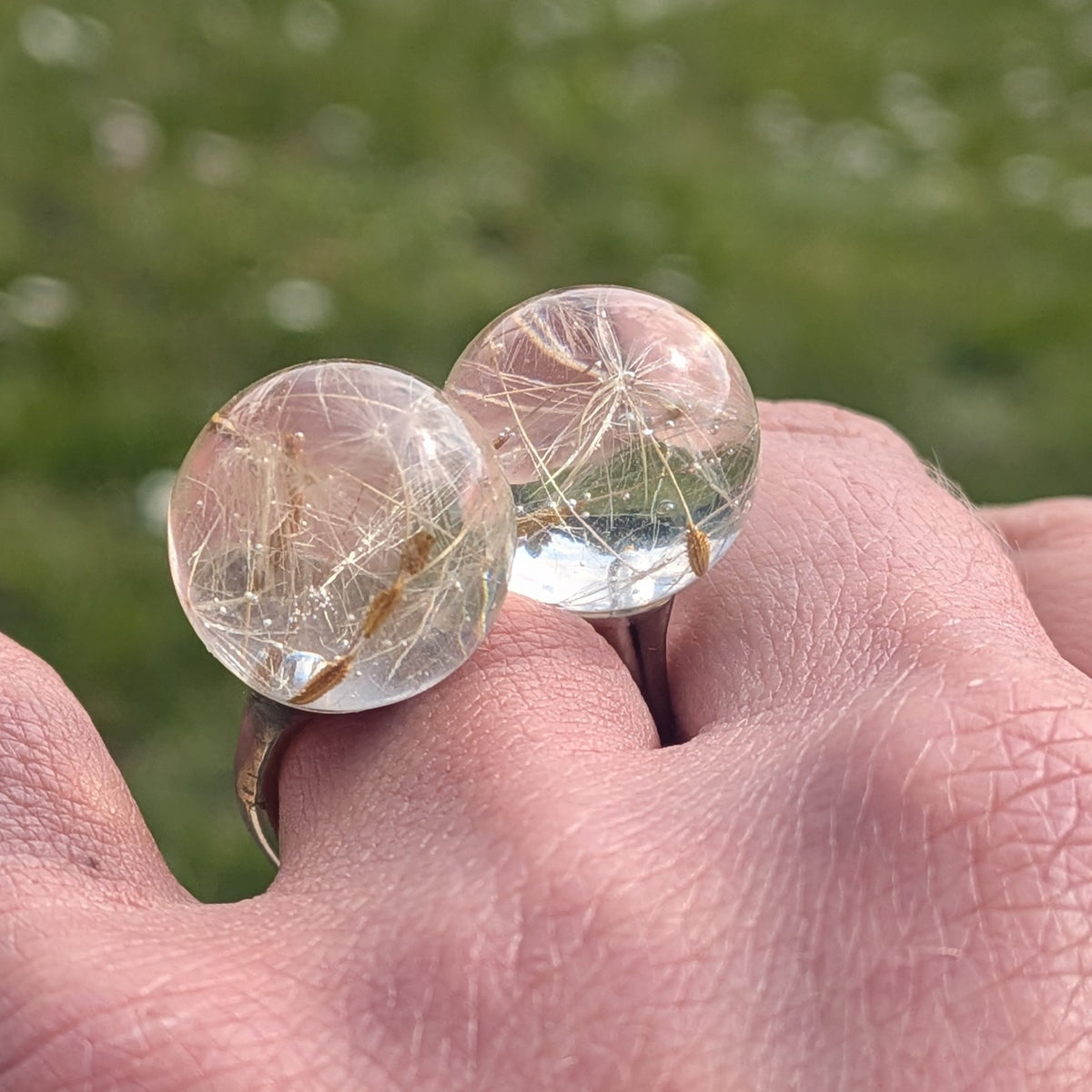 Adjustable dandelion ring with preserved seeds in clear resin, side view, EL-Creations