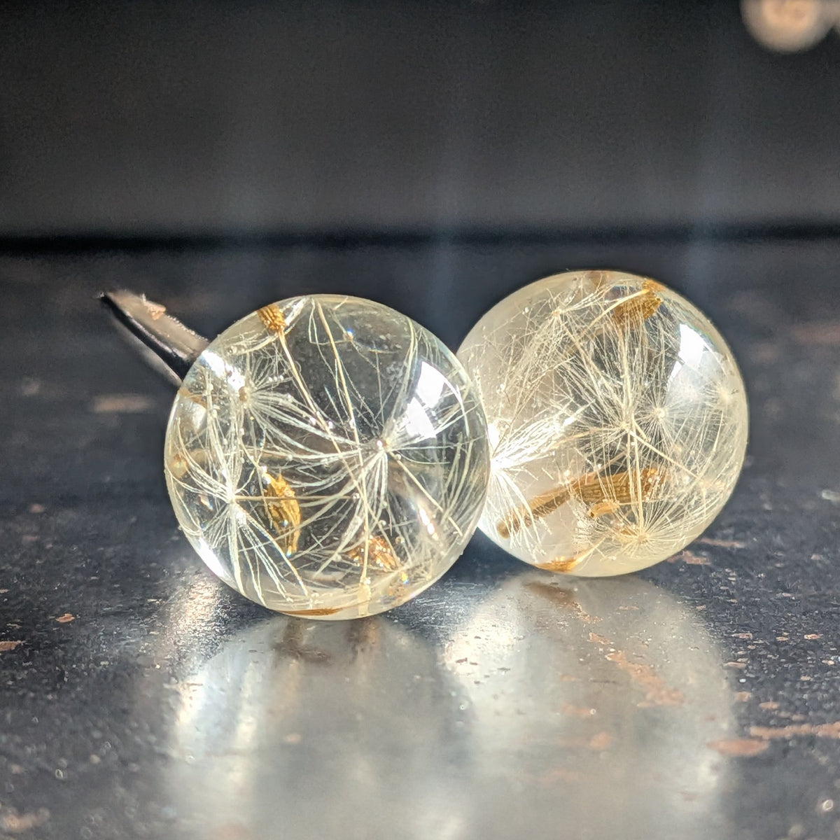 Dandelion wish ring on wooden surface, nature-inspired resin jewelry, EL-Creations