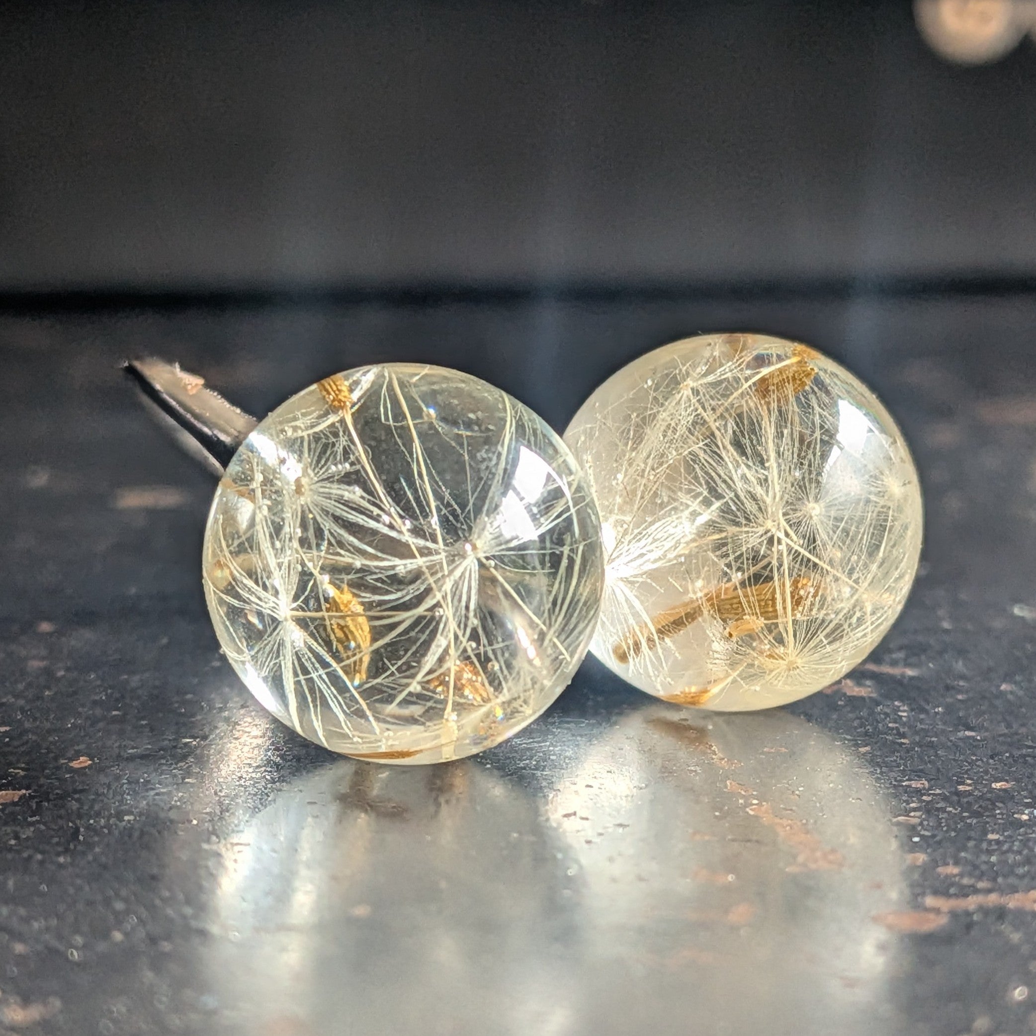 Dandelion wish ring on wooden surface, nature-inspired resin jewelry, EL-Creations