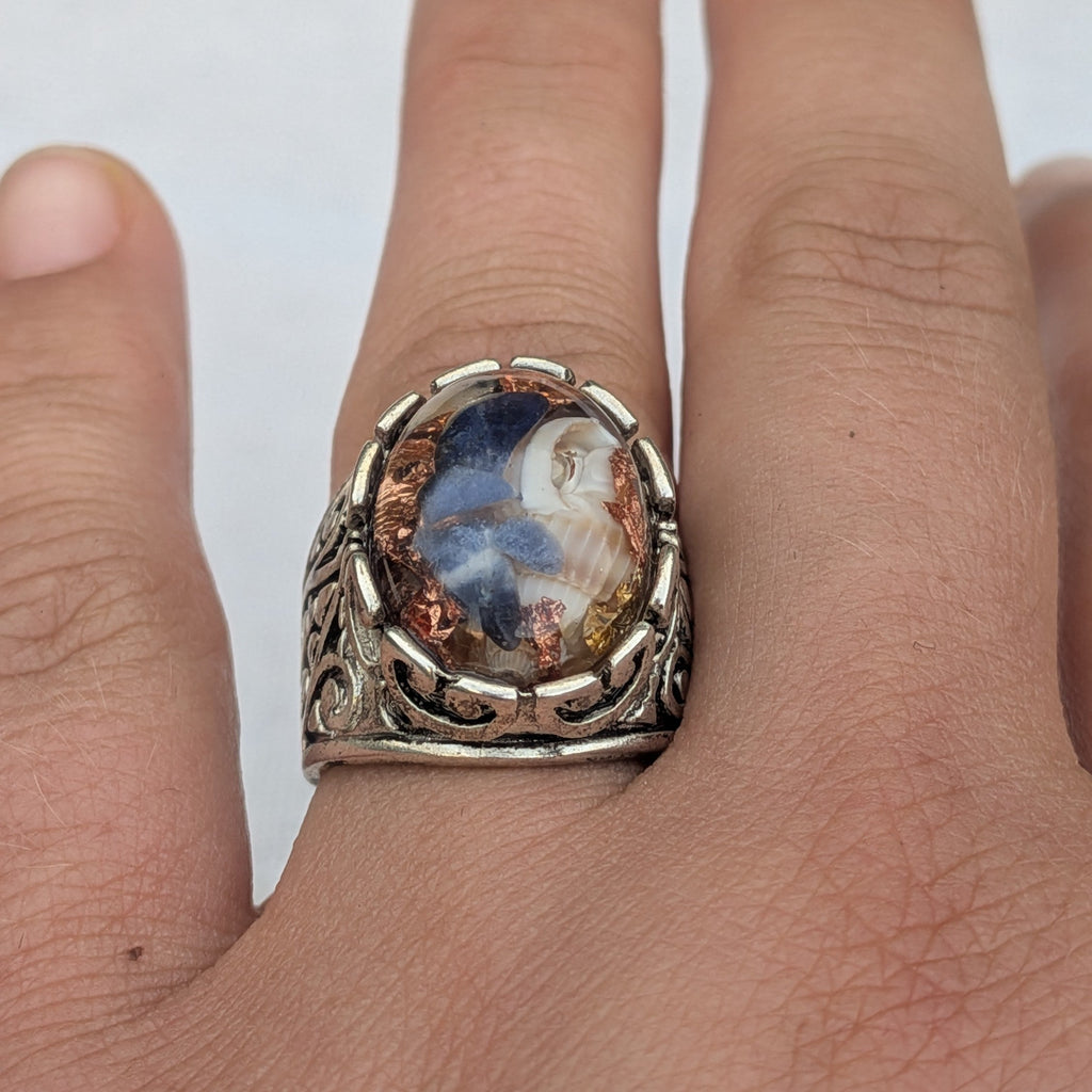 Handmade resin ring with sodalite fragments natural shells and copper flakes front view on wood – EL-Creations