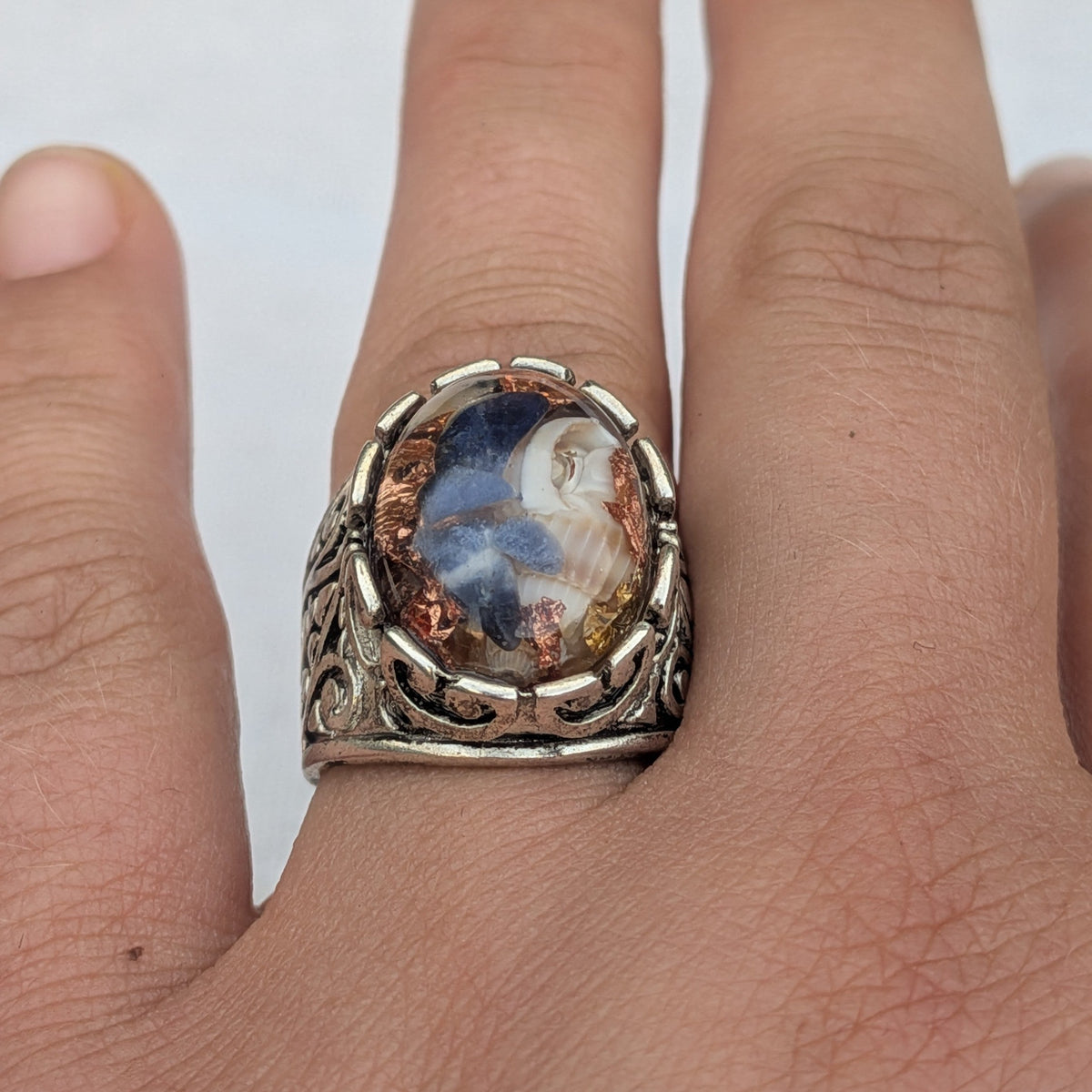 Handmade resin ring with sodalite fragments natural shells and copper flakes front view on wood – EL-Creations