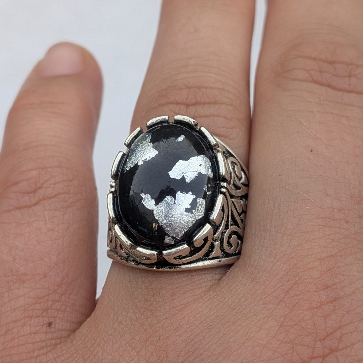 Black resin silver flakes statement ring side view showing baroque filigree scrollwork on wood – EL-Creations