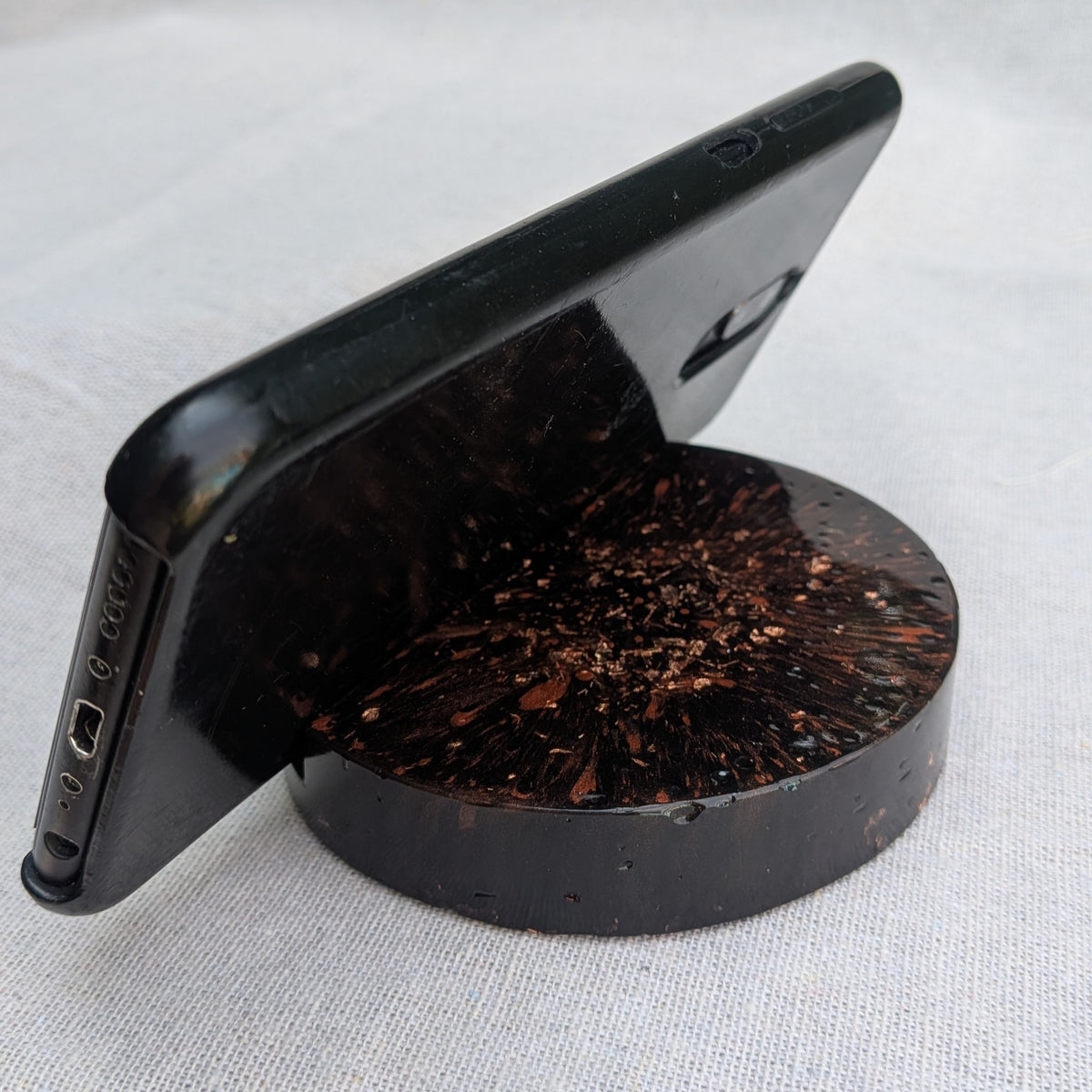 Back view of phone in black resin stand with copper flakes – unique handmade desk accessory – EL-CreationS