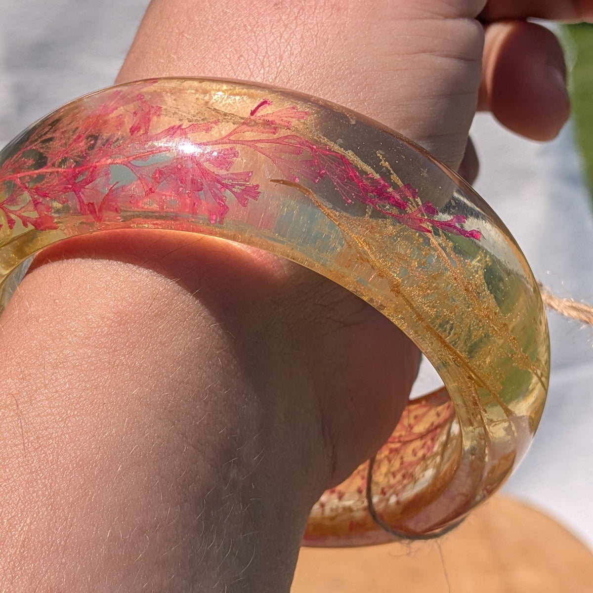 Handmade wide amber resin bangle with red fern and gold shimmer by EL-Creations