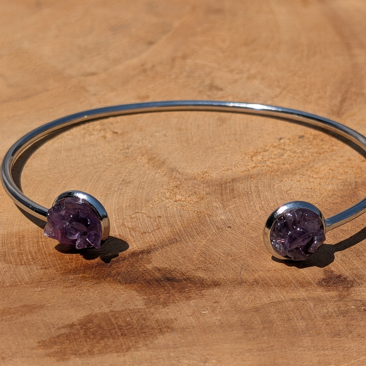 Raw amethyst resin cuff bracelet worn on wrist in sunlight – EL-Creations