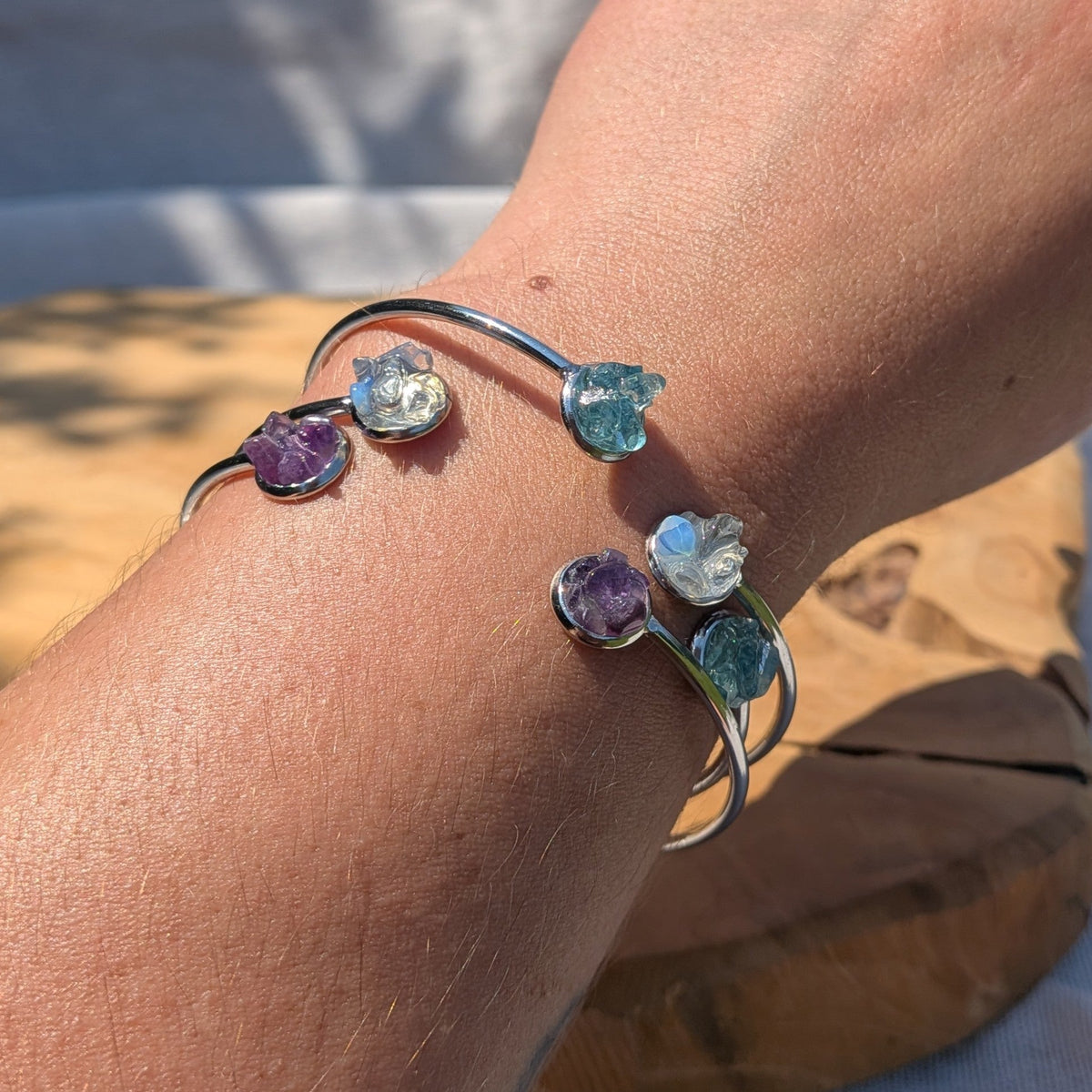 Collection of raw crystal cuff bracelets amethyst aquamarine moonstone on wrist – EL-Creations