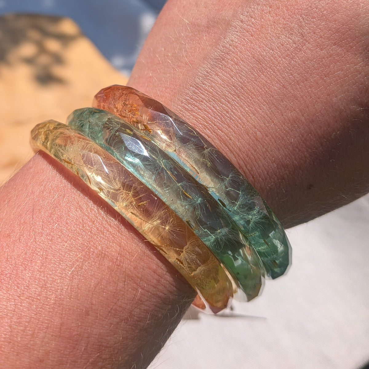 Ombre peach yellow mint resin bangle bracelets with real dandelion seeds in sunlight by EL-Creations