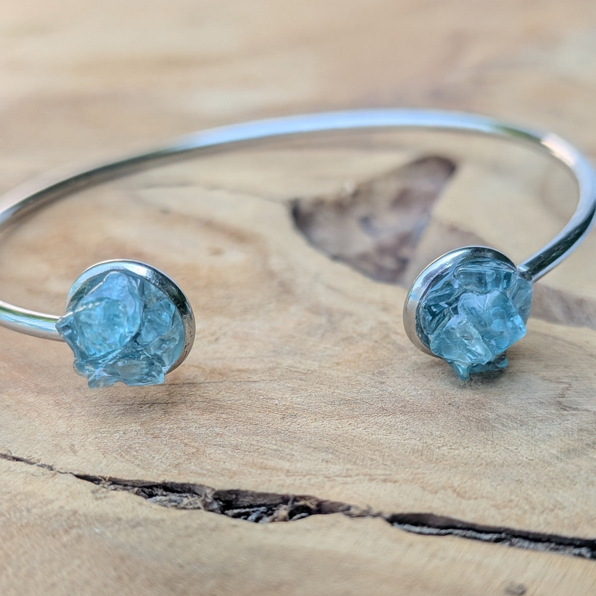 Two raw blue topaz cuff bracelets flat lay on wooden surface – EL-Creations