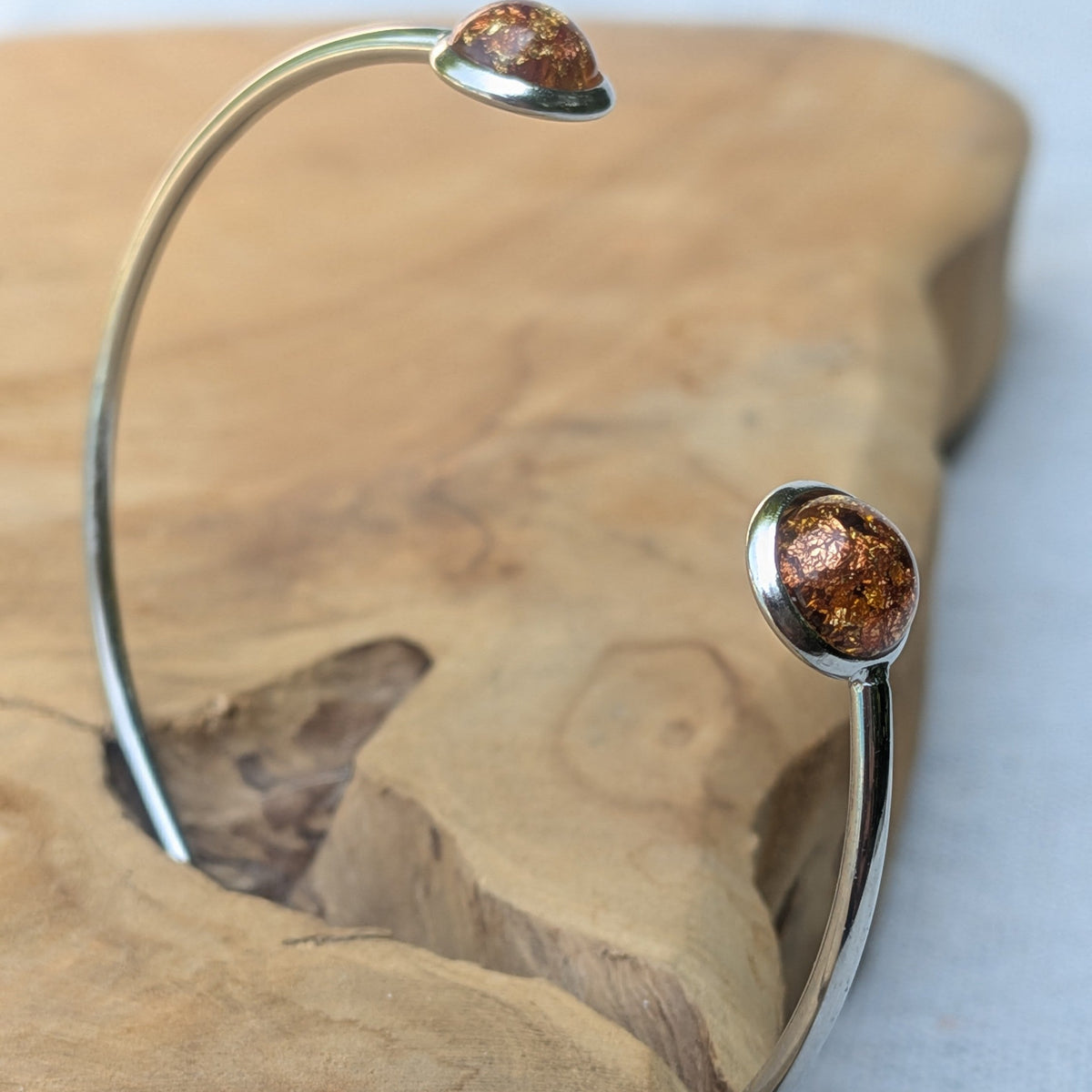Amber resin cuff bracelet with copper foil flakes on white background – EL-Creations