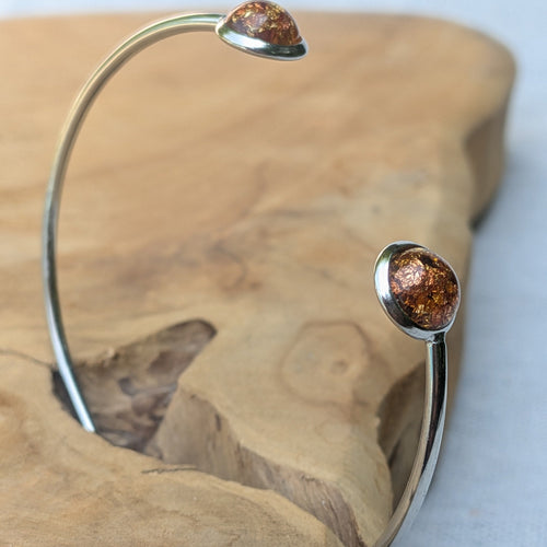 Amber resin cuff bracelet with copper foil flakes on white background – EL-Creations
