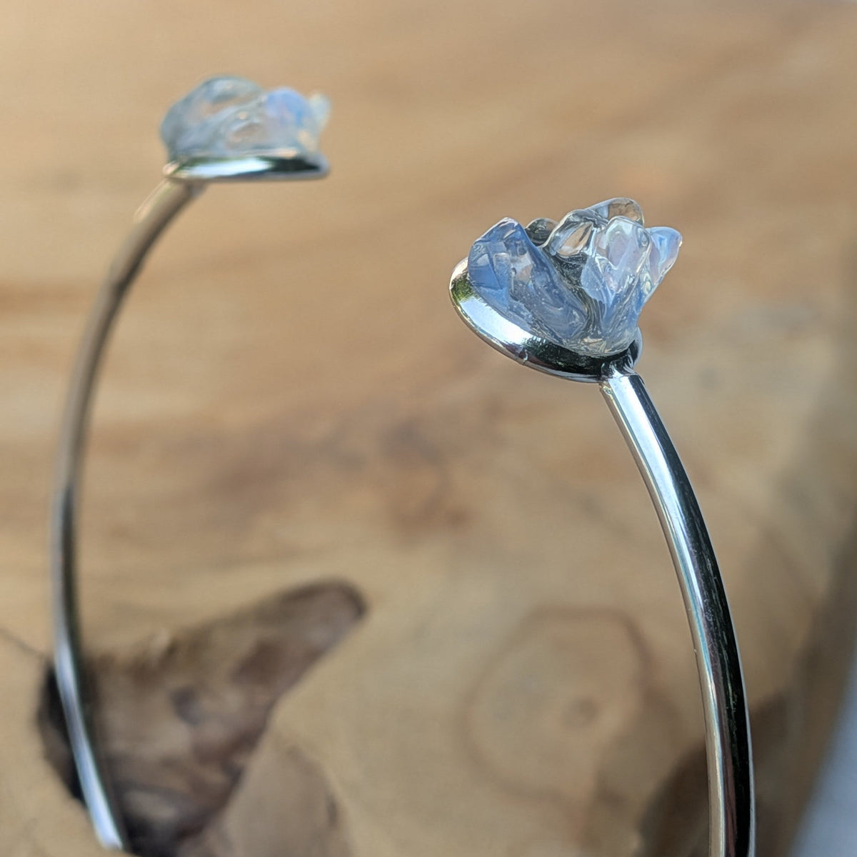 Two moonstone stainless steel cuff bracelets side view on wood – EL-Creations