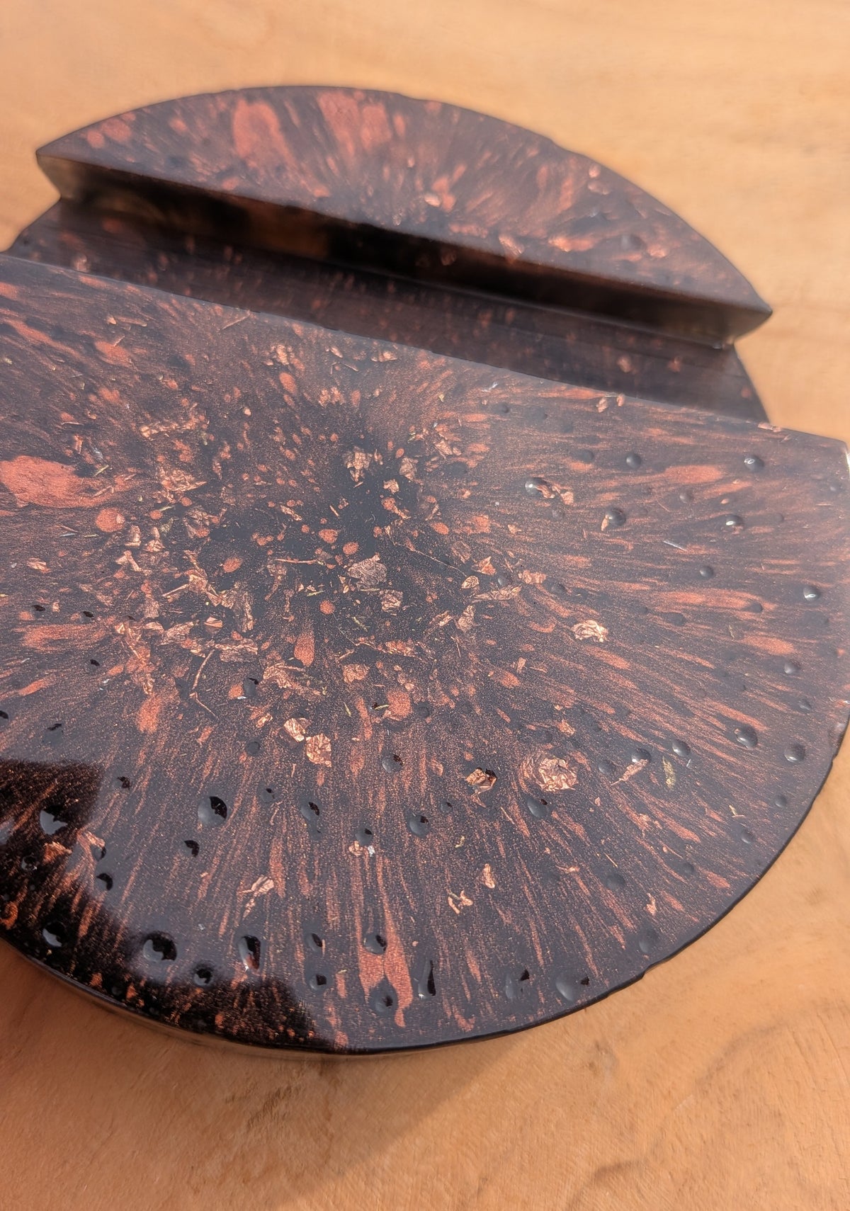 Side view of round black resin phone stand with copper flakes – moody luxury desk accessory – EL-CreationS