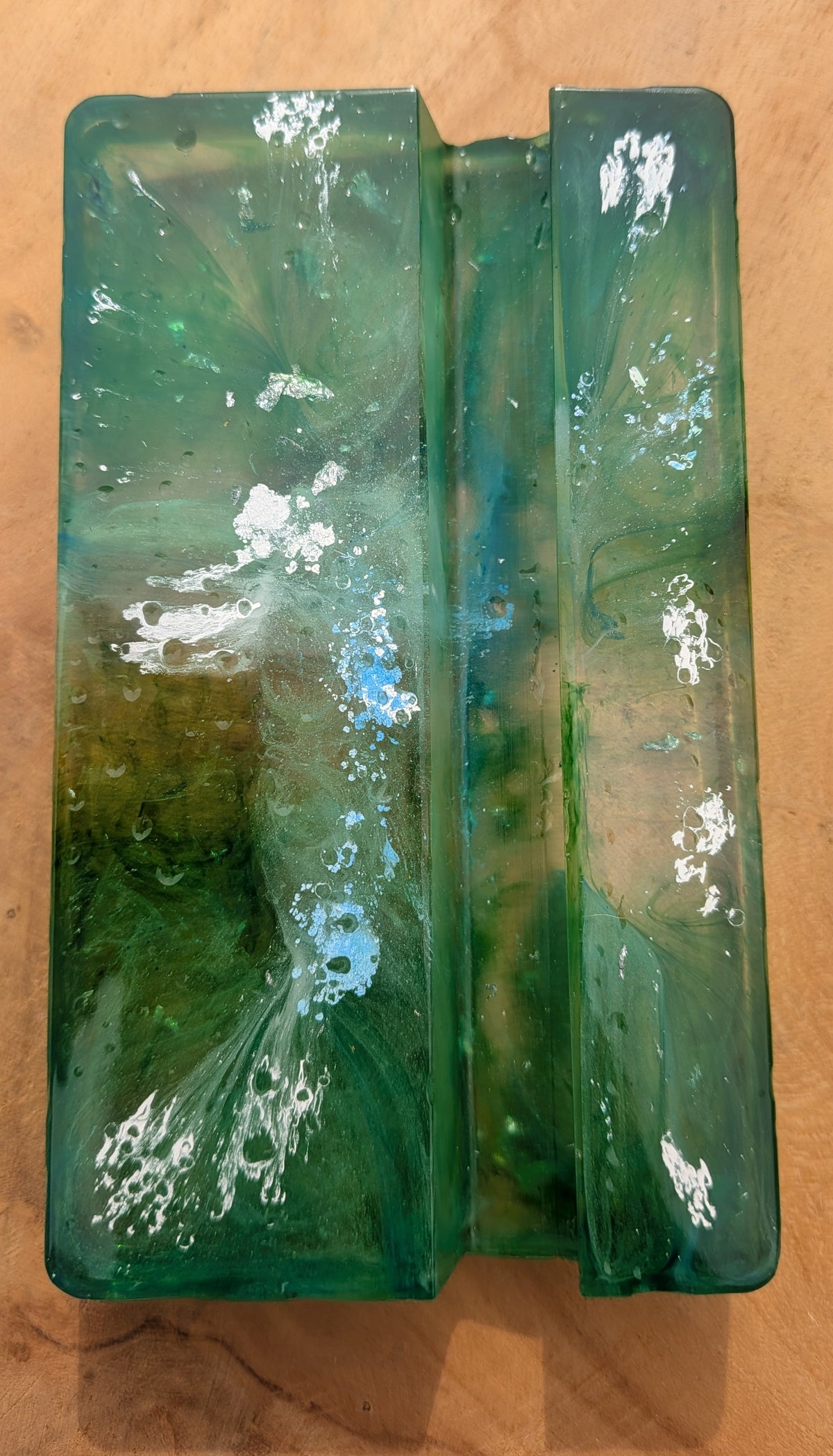 Smartphone resting in green resin phone stand – handmade marble effect desk accessory, fits most phones – EL-CreationS